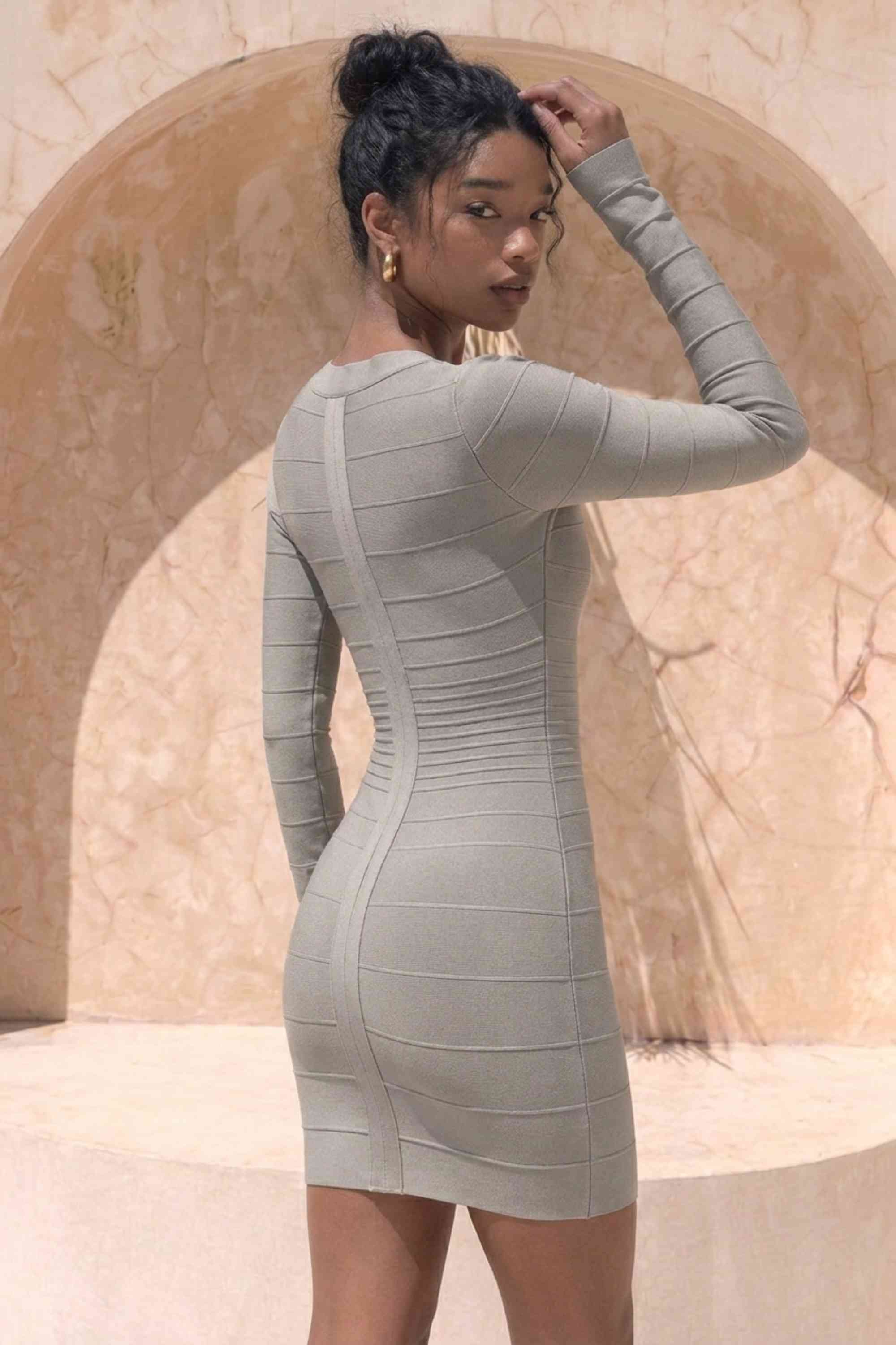 Woman wearing a figure flattering Valentina Long Sleeve Bandage Mini Dress - Oyster Grey BODYCON COLLECTION Pty Ltd
