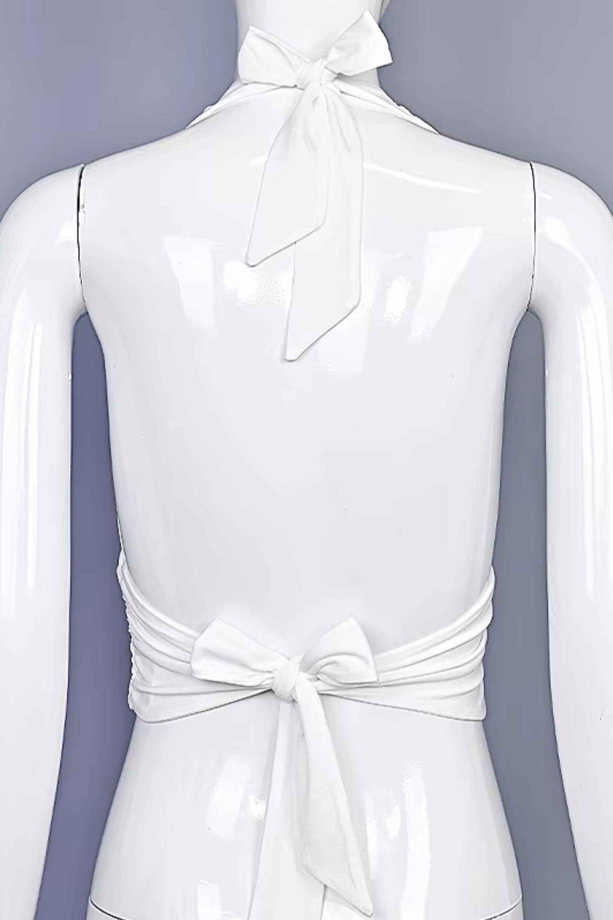 Woman wearing a figure flattering Aby Halter Top - White Pearl BODYCON COLLECTION Pty Ltd