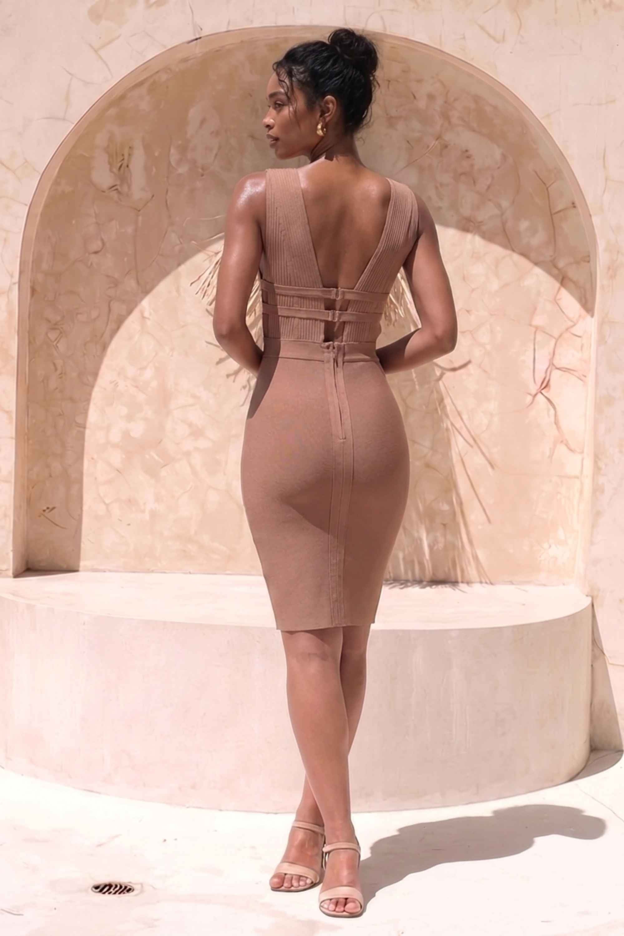 Woman wearing a figure flattering Bay Bandage Dress - Nude Bodycon Collection