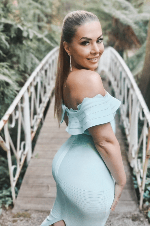 Woman wearing a figure flattering Billie Bandage Midi Dress - Mint Green Bodycon Collection