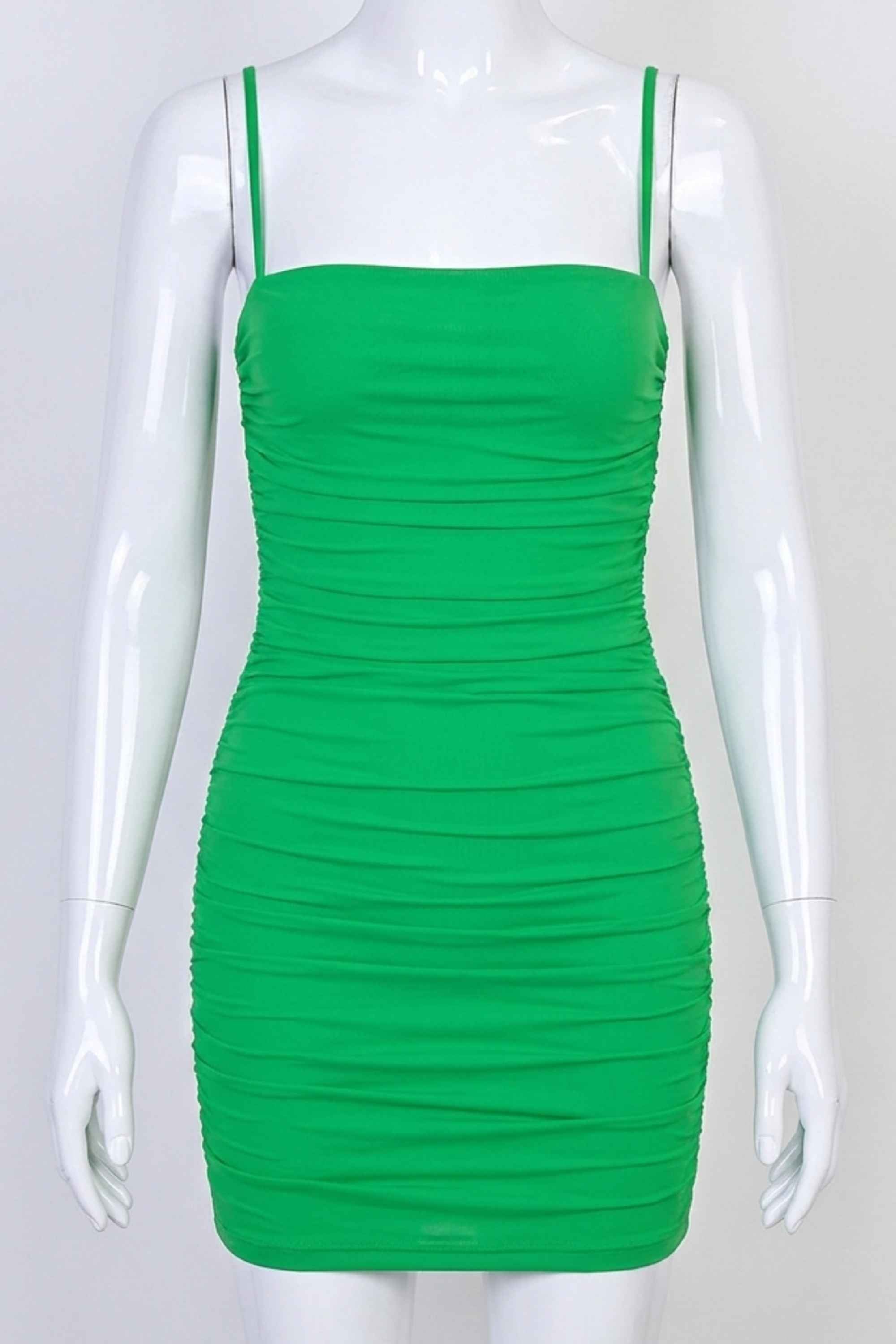 Woman wearing a figure flattering Cassie Bodycon Wrap Mini Dress - Emerald Green BODYCON COLLECTION