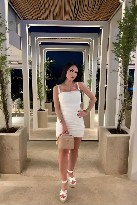 Woman wearing a figure flattering Cassie Bodycon Wrap Mini Dress - Pearl White BODYCON COLLECTION