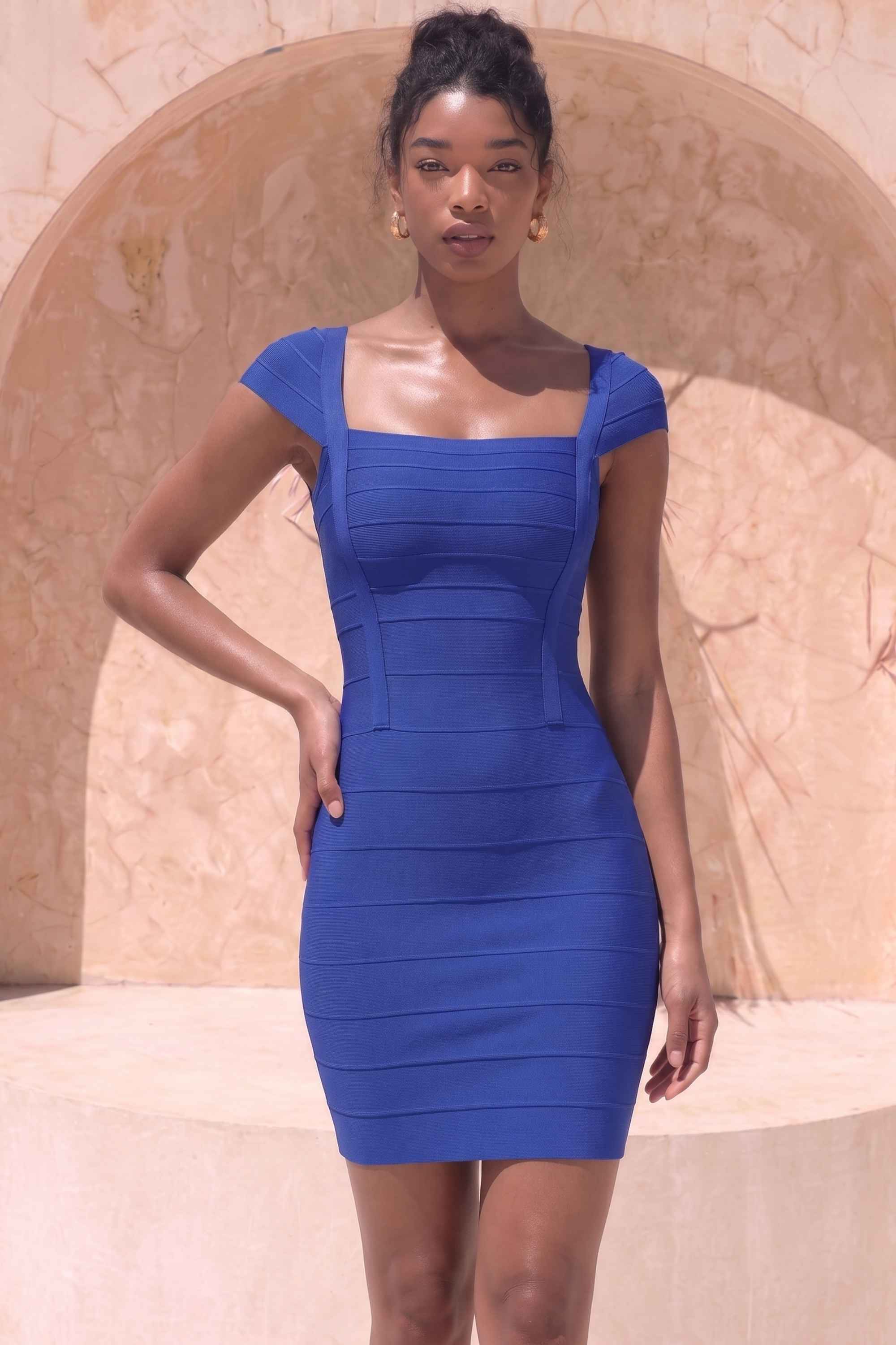 Woman wearing a figure flattering Celine Bandage Mini Dress - Navy Blue BODYCON COLLECTION Pty Ltd