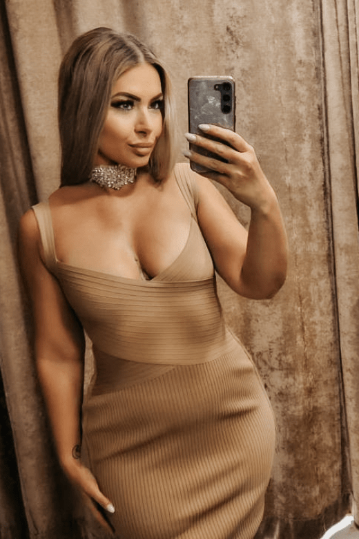 Woman wearing a figure flattering Ciara Bandage Dress - Tan Brown Bodycon Collection