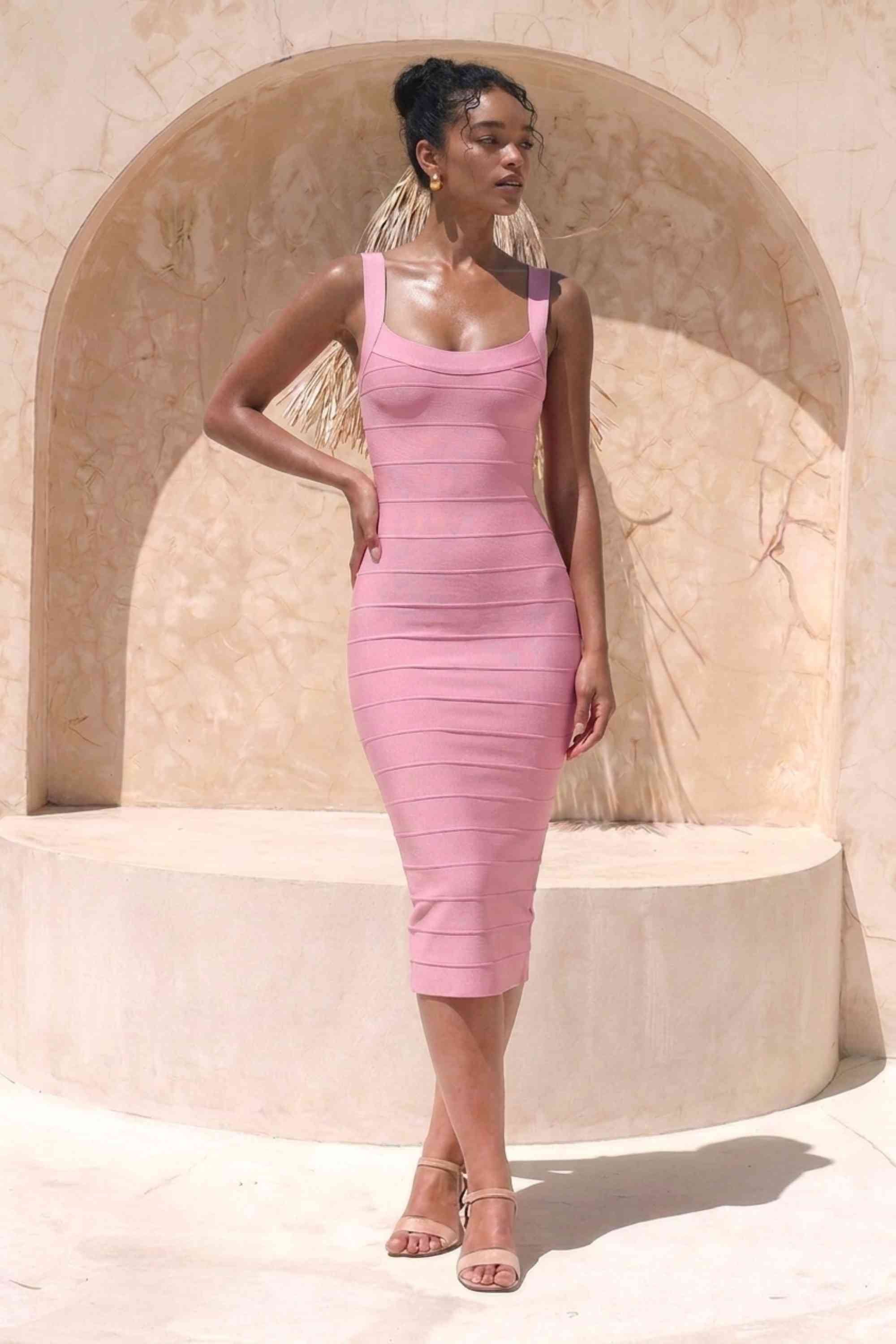 Woman wearing a figure flattering Cindy Bandage Midi Dress - Blush Pink BODYCON COLLECTION Pty Ltd