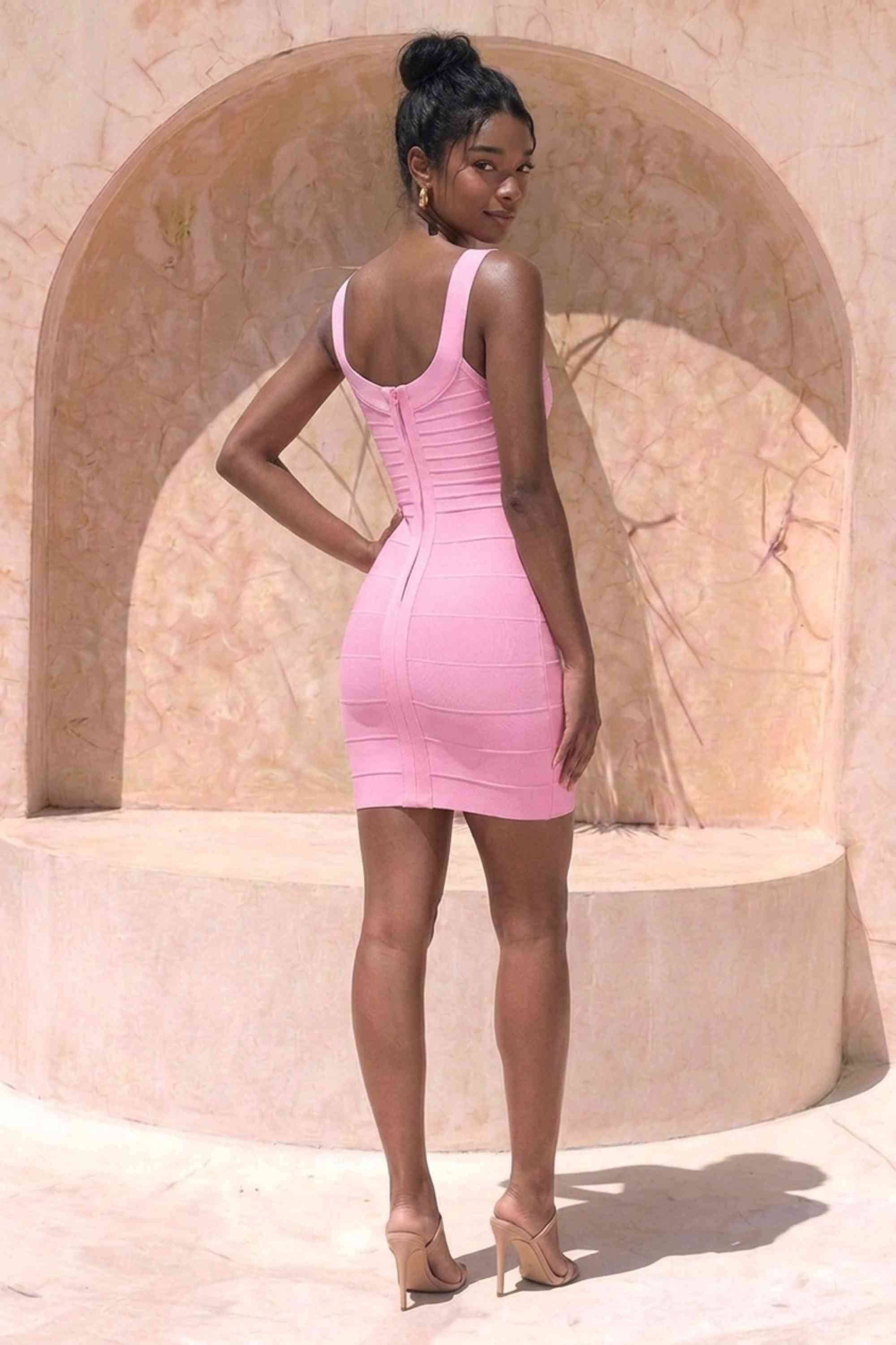 Woman wearing a figure flattering Cindy Bandage Mini Dress - Blush Pink BODYCON COLLECTION Pty Ltd