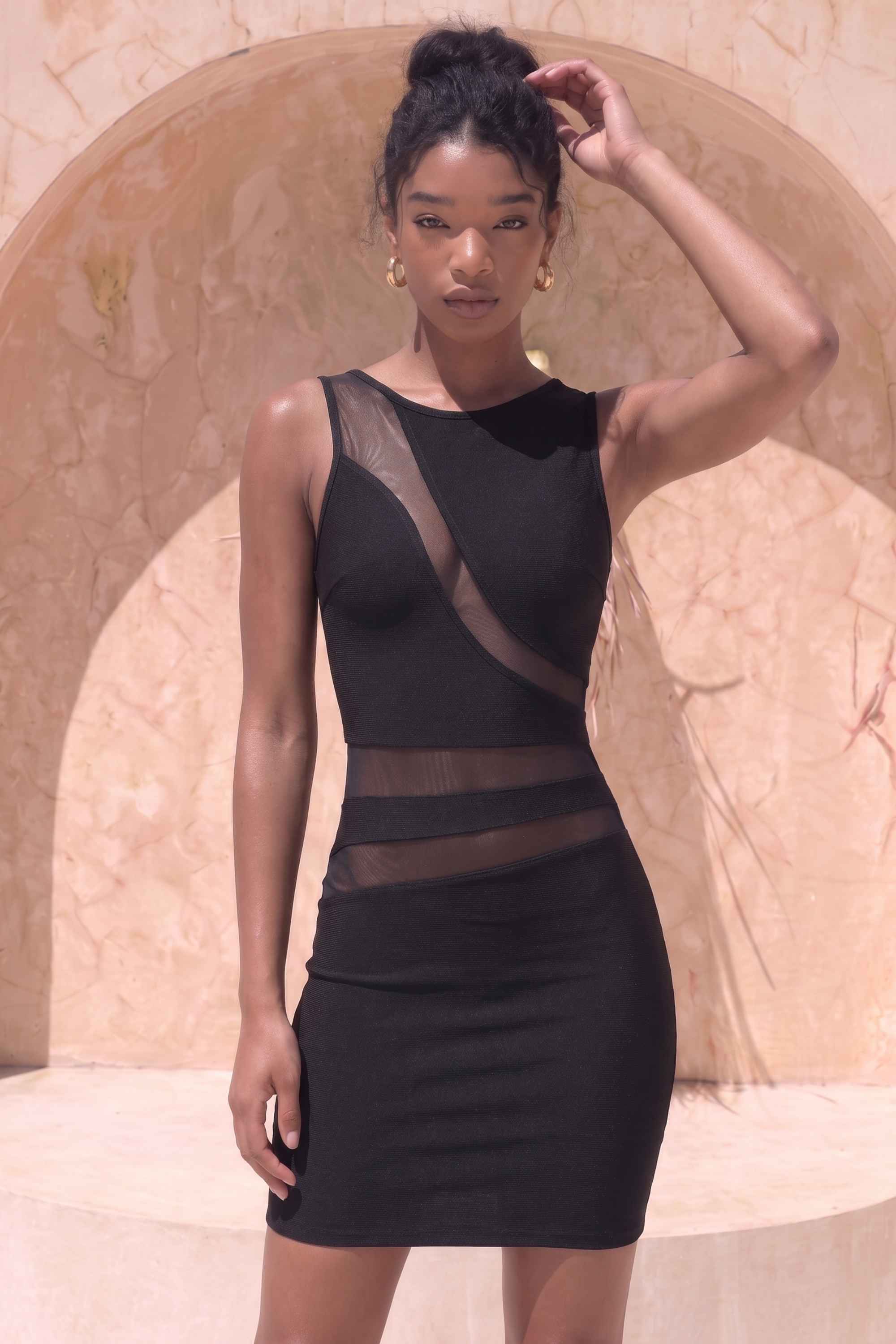 Woman wearing a figure flattering Ellie Bodycon Mini Dress - Classic Black BODYCON COLLECTION Pty Ltd