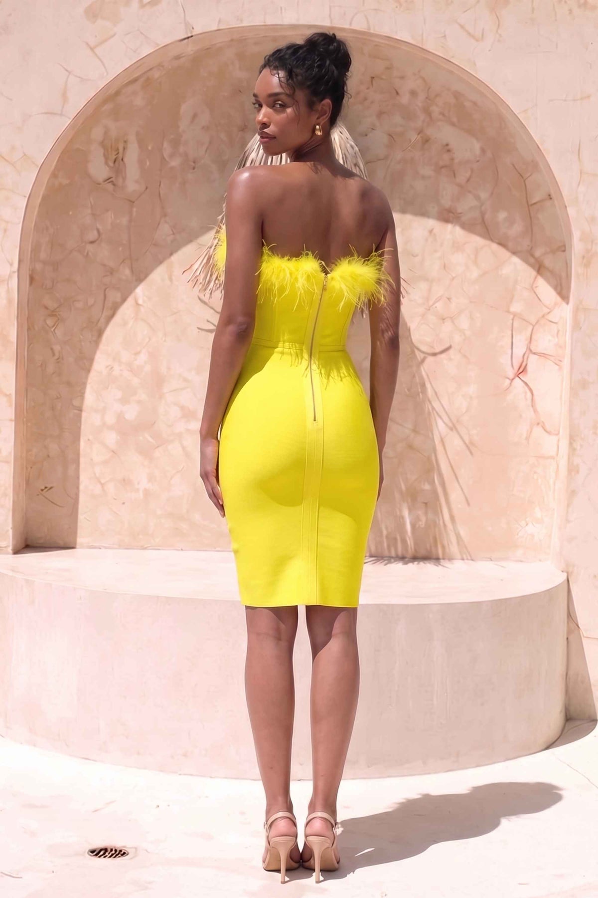 Woman wearing a figure flattering Erin Bandage Dress - Sun Yellow BODYCON COLLECTION