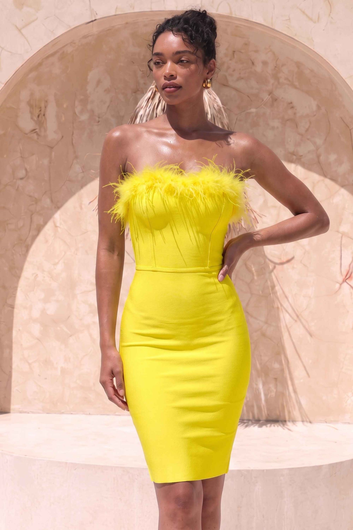 Woman wearing a figure flattering Erin Bodycon Dress - Sun Yellow BODYCON COLLECTION