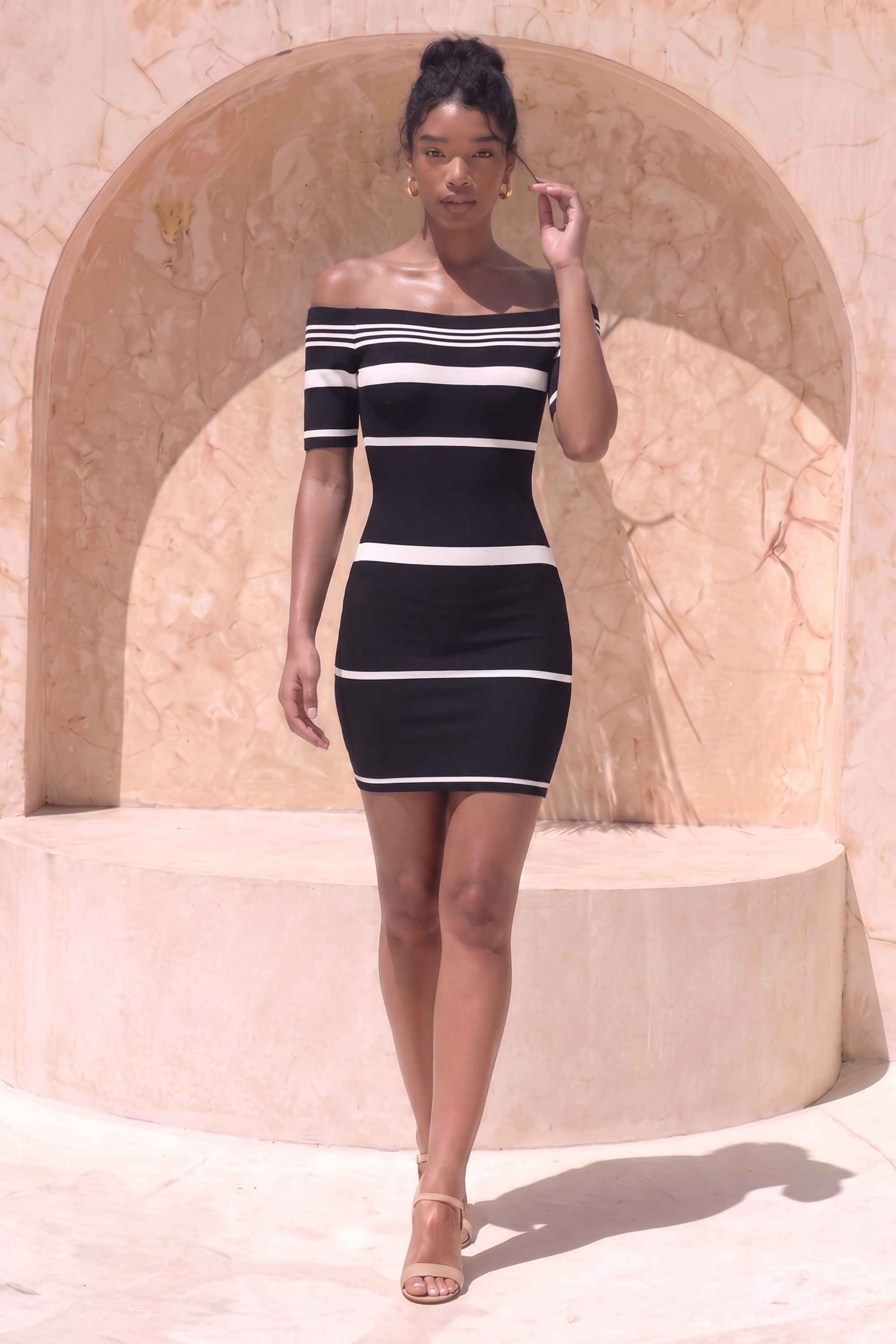 Woman wearing a figure flattering Evelyn Bandage Mini Dress - Classic Black BODYCON COLLECTION Pty Ltd
