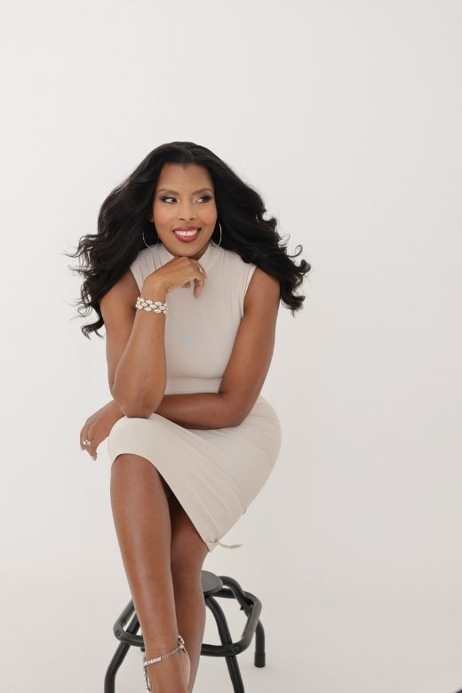 Woman wearing a figure flattering Grace Bandage Midi Dress - Cream Bodycon Collection