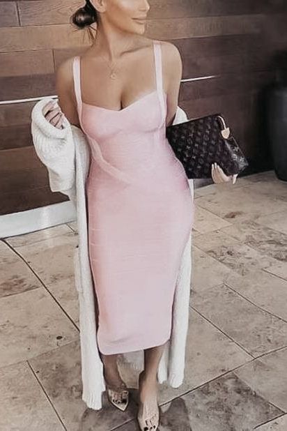 Woman wearing a figure flattering Heidi Bandage Midi Dress - Magenta Pink Bodycon Collection