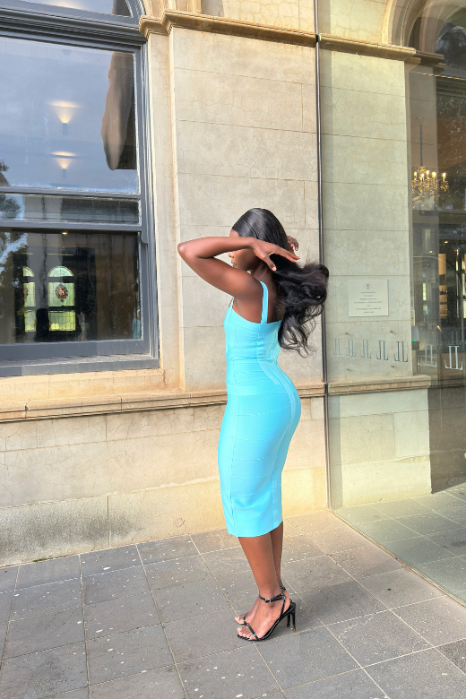 Woman wearing a figure flattering Heidi Bandage Midi Dress - Sky Blue Bodycon Collection