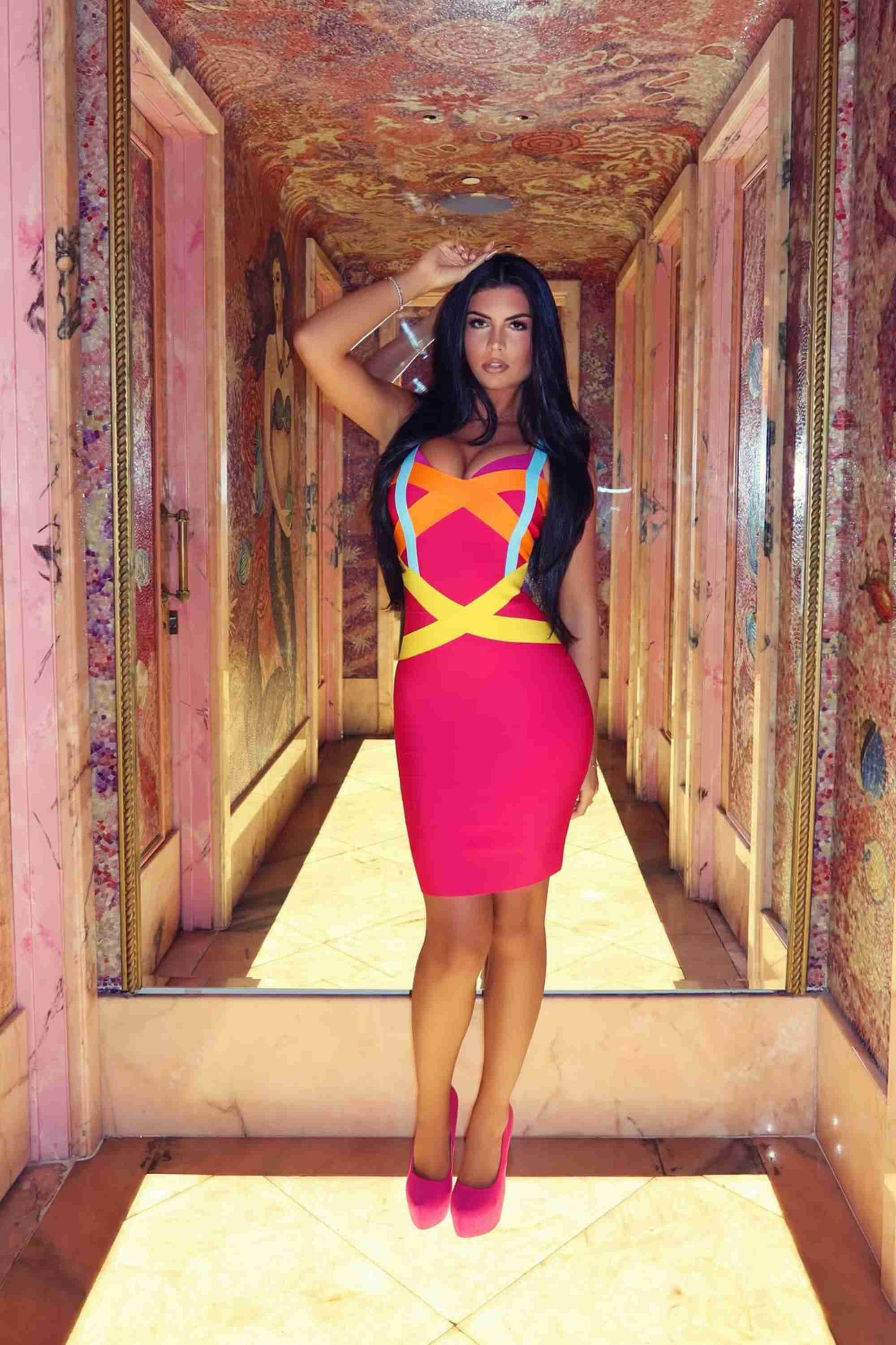 Woman wearing a figure flattering Heidi Bandage Mini Dress - Hot Pink Bodycon Collection