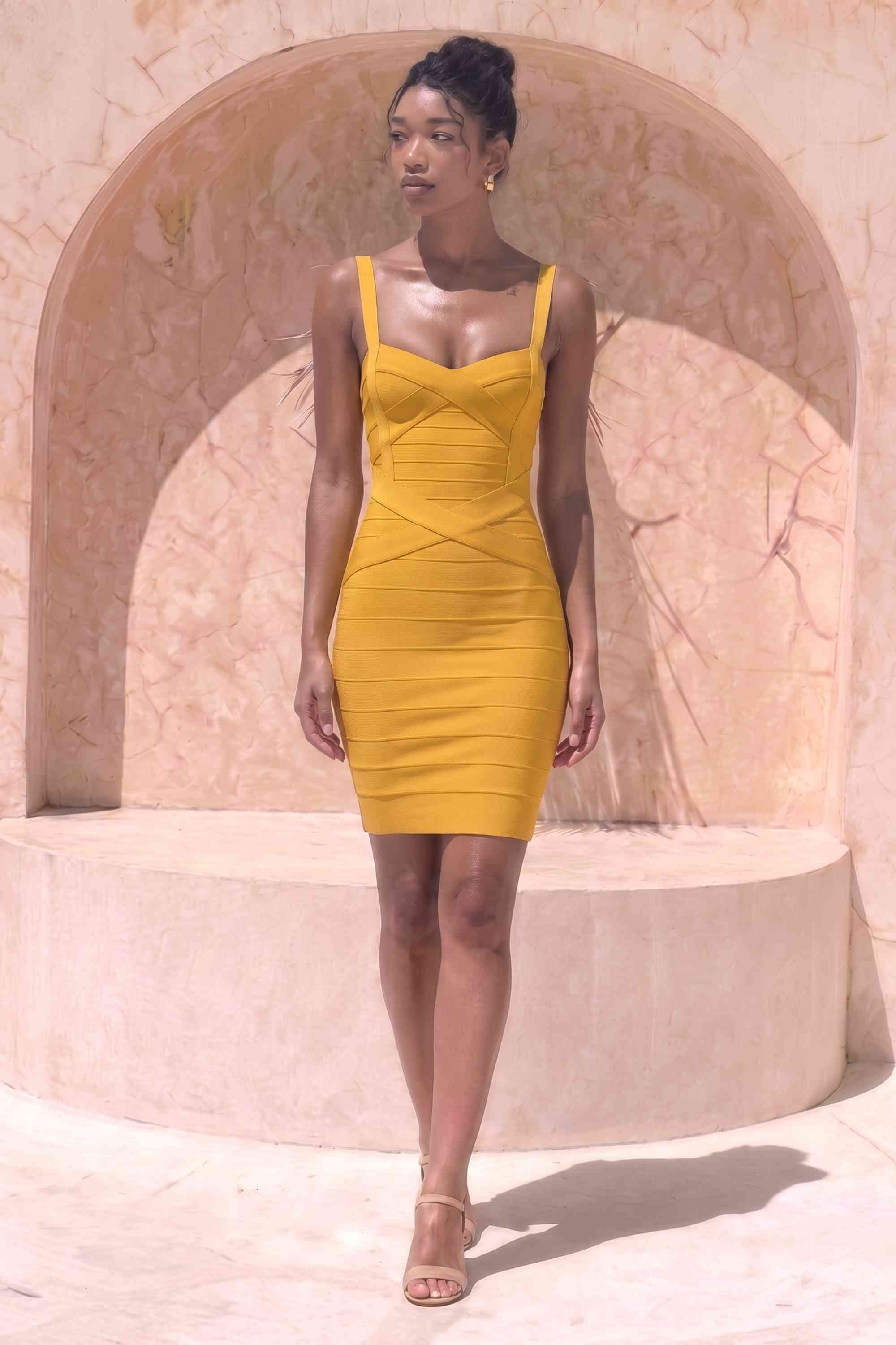 Woman wearing a figure flattering Heidi Bandage Mini Dress - Mustard Yellow Bodycon Collection