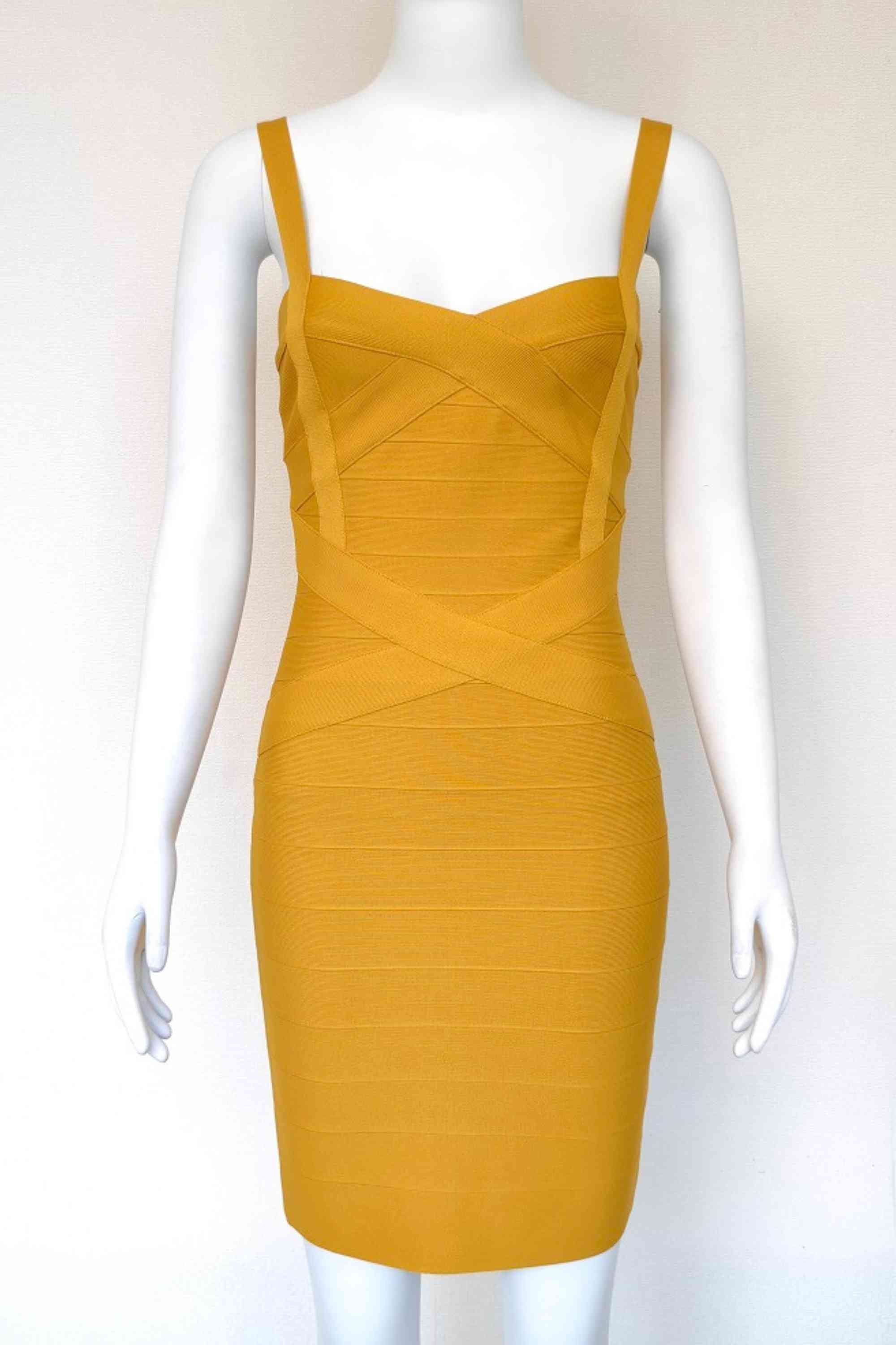Woman wearing a figure flattering Heidi Bandage Mini Dress - Mustard Yellow Bodycon Collection