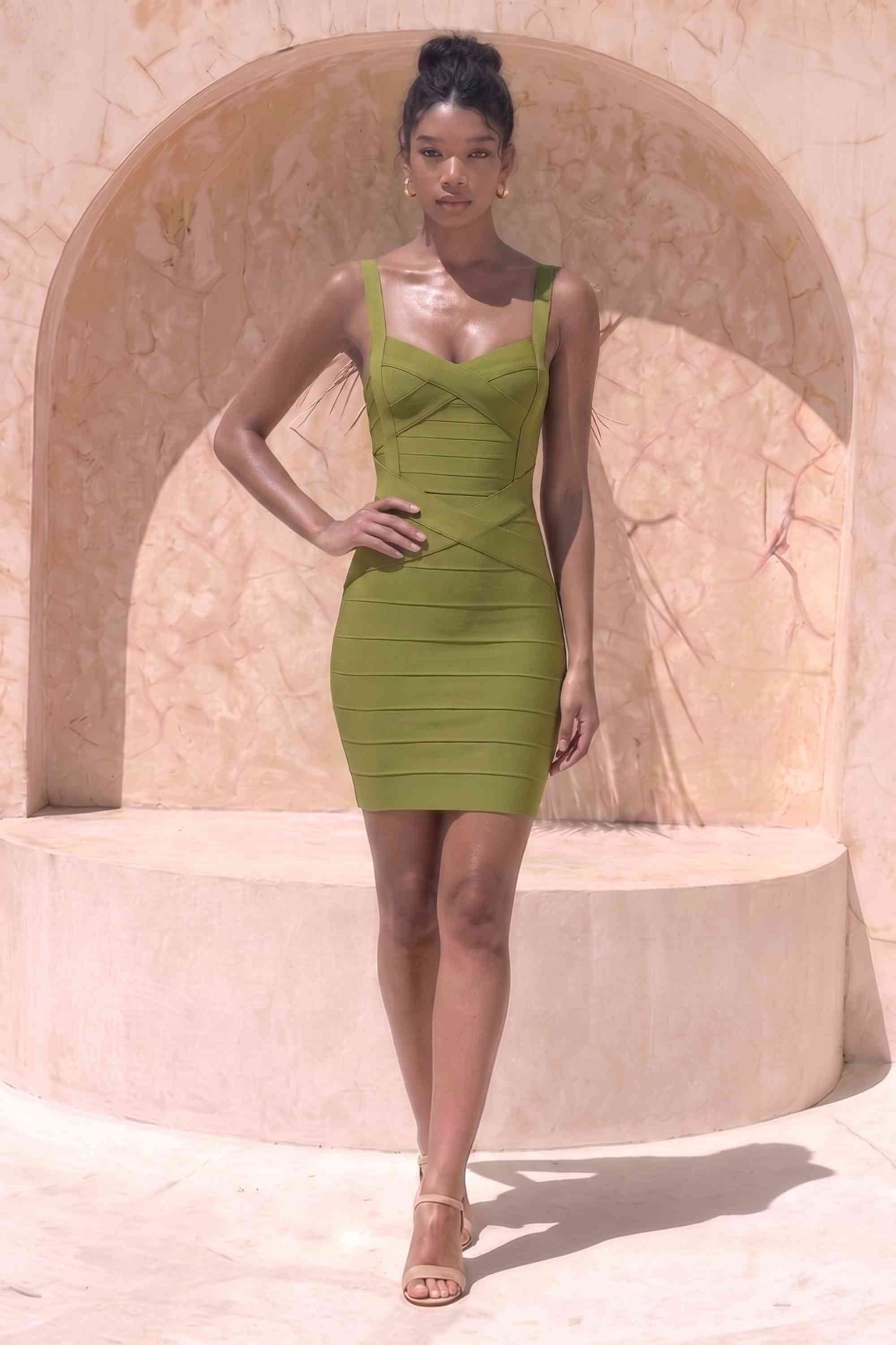 Woman wearing a figure flattering Heidi Bandage Mini Dress - Olive Green Bodycon Collection