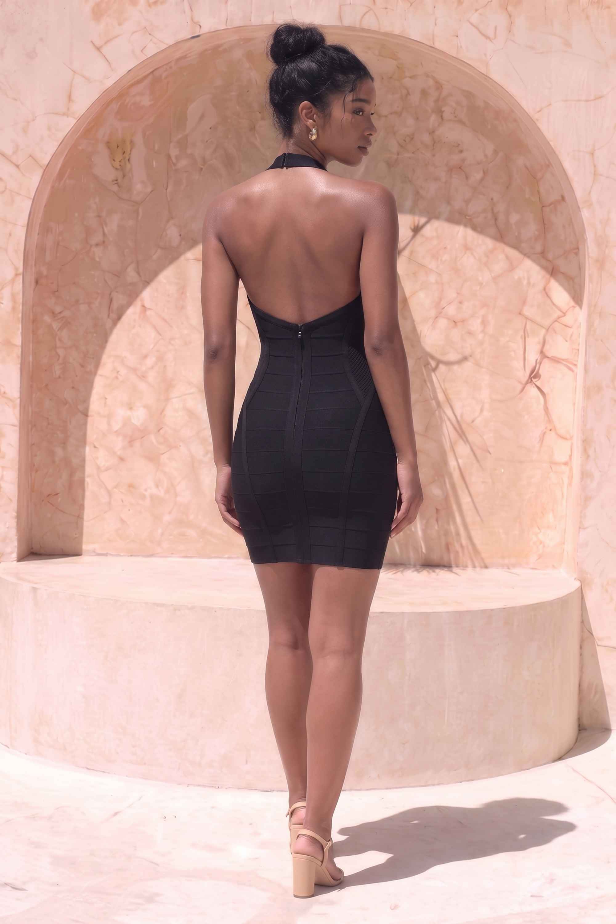 Woman wearing a figure flattering Isabella Bandage Mini Dress - Classic Black BODYCON COLLECTION Pty Ltd