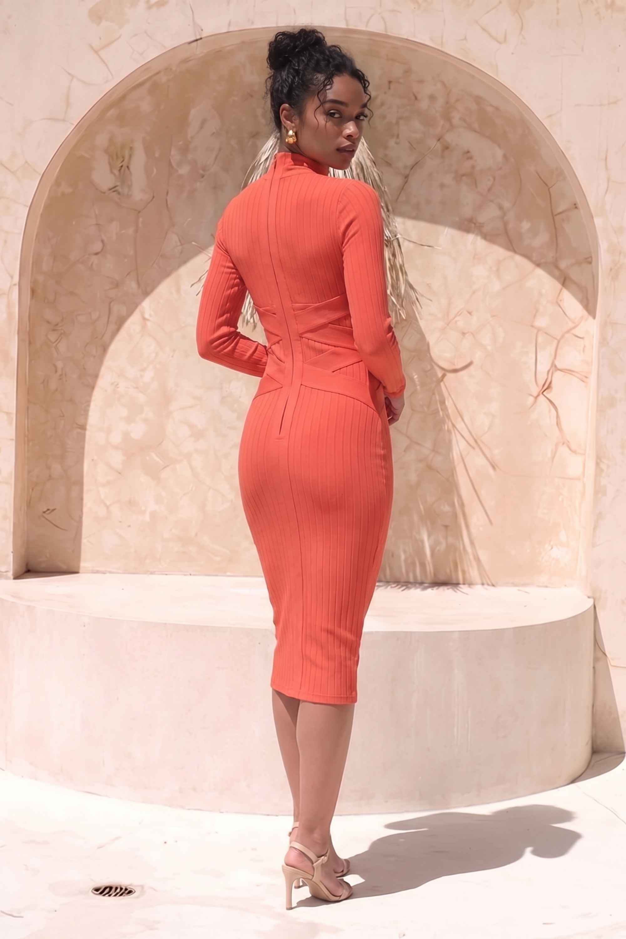 Woman wearing a figure flattering Jane Long Sleeve Bodycon Midi Dress - Lipstick Red Bodycon Collection