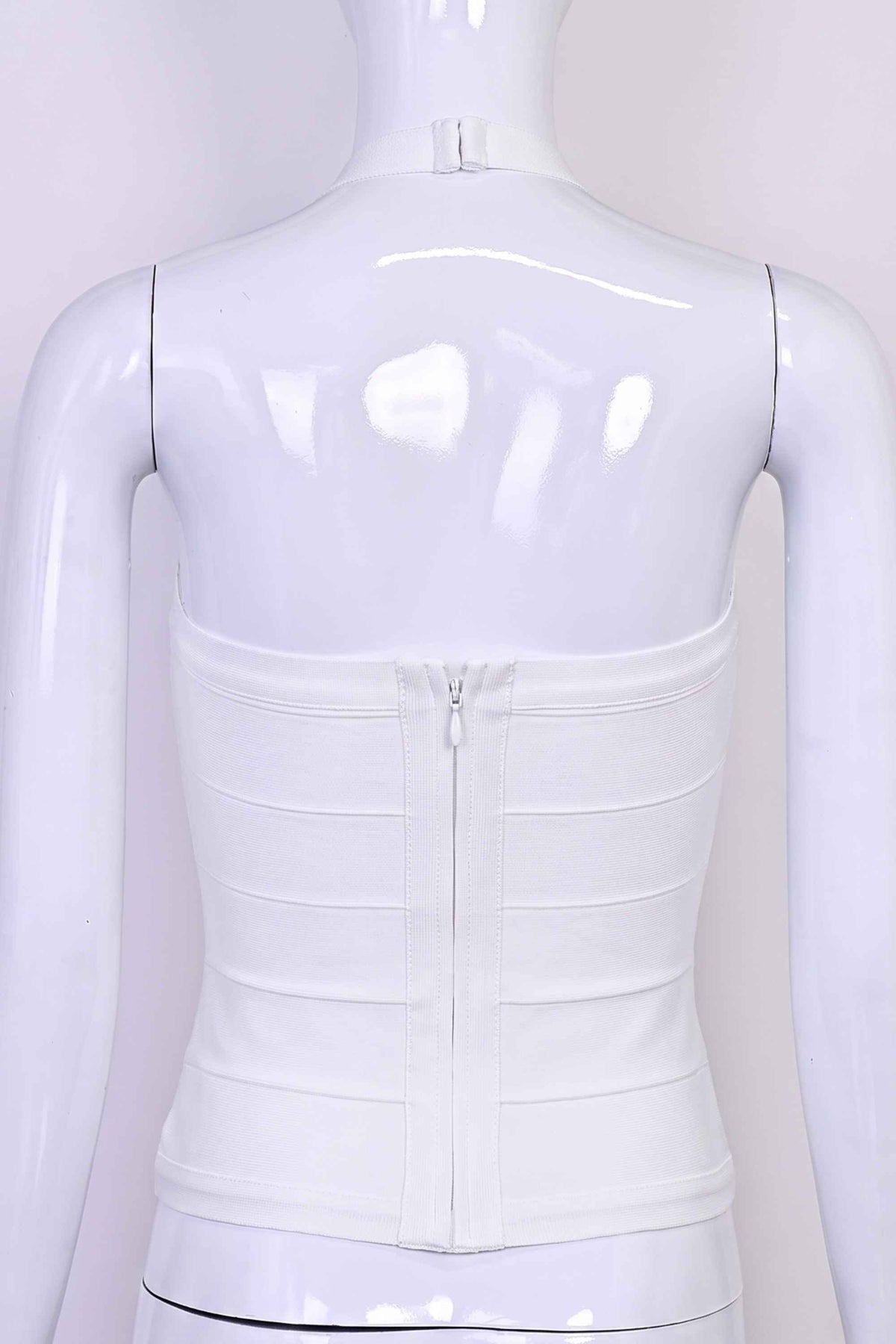 Woman wearing a figure flattering Jenna Bandage Top - White Pearl BODYCON COLLECTION Pty Ltd