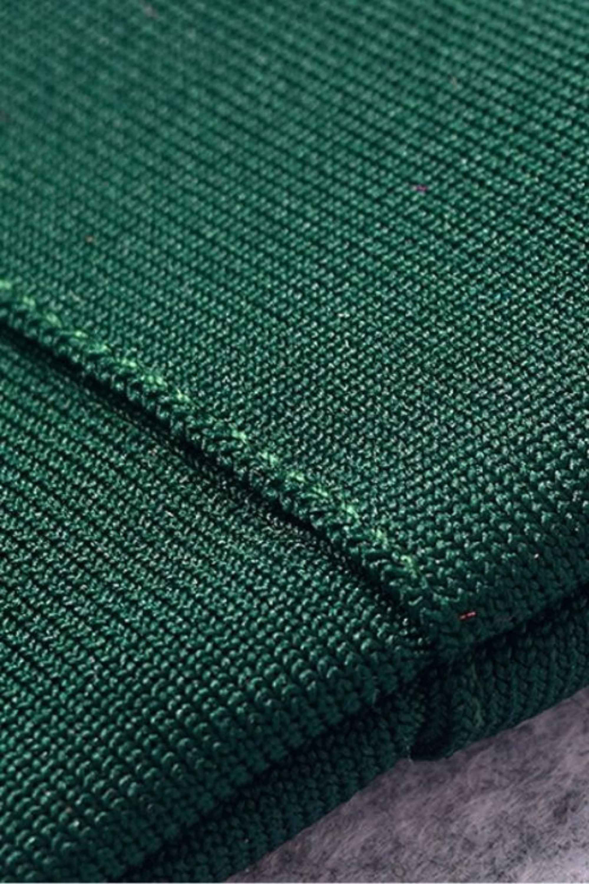Woman wearing a figure flattering Josie Bandage V Neck Mini Dress - Emerald Green BODYCON COLLECTION