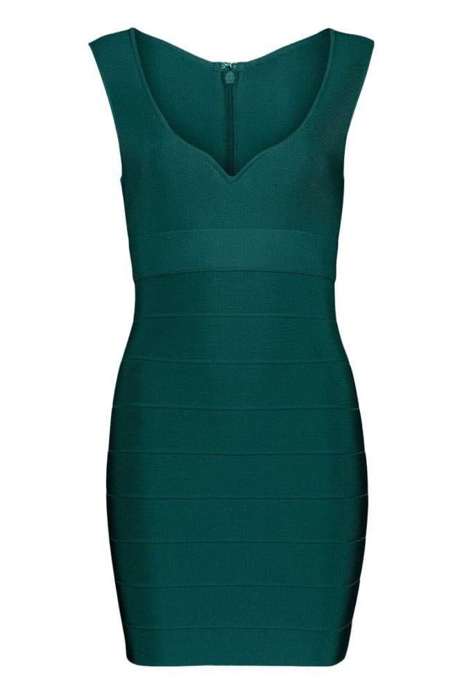 Woman wearing a figure flattering Josie Bandage V Neck Mini Dress - Emerald Green BODYCON COLLECTION