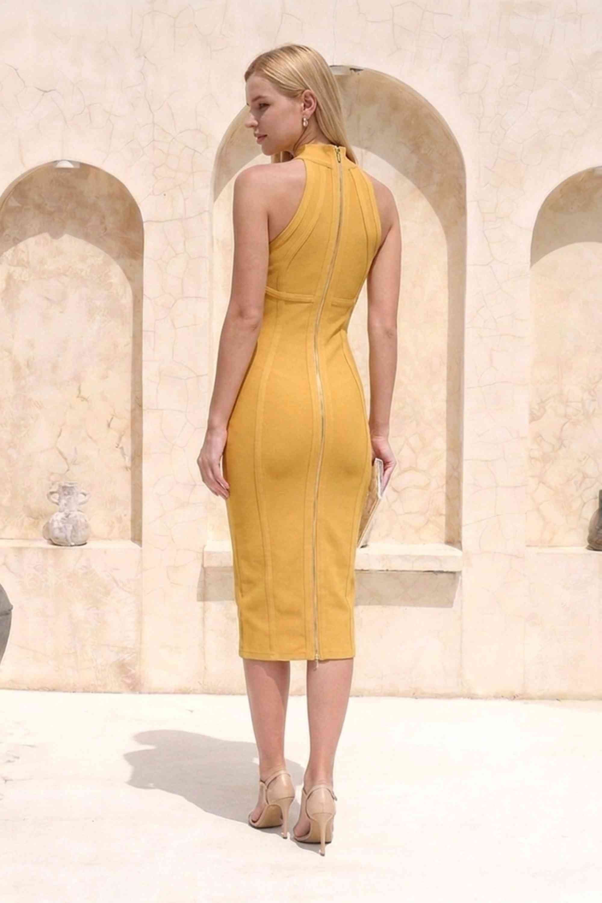 Woman wearing a figure flattering Lea Bandage Midi Dress - Mustard Yellow Bodycon Collection