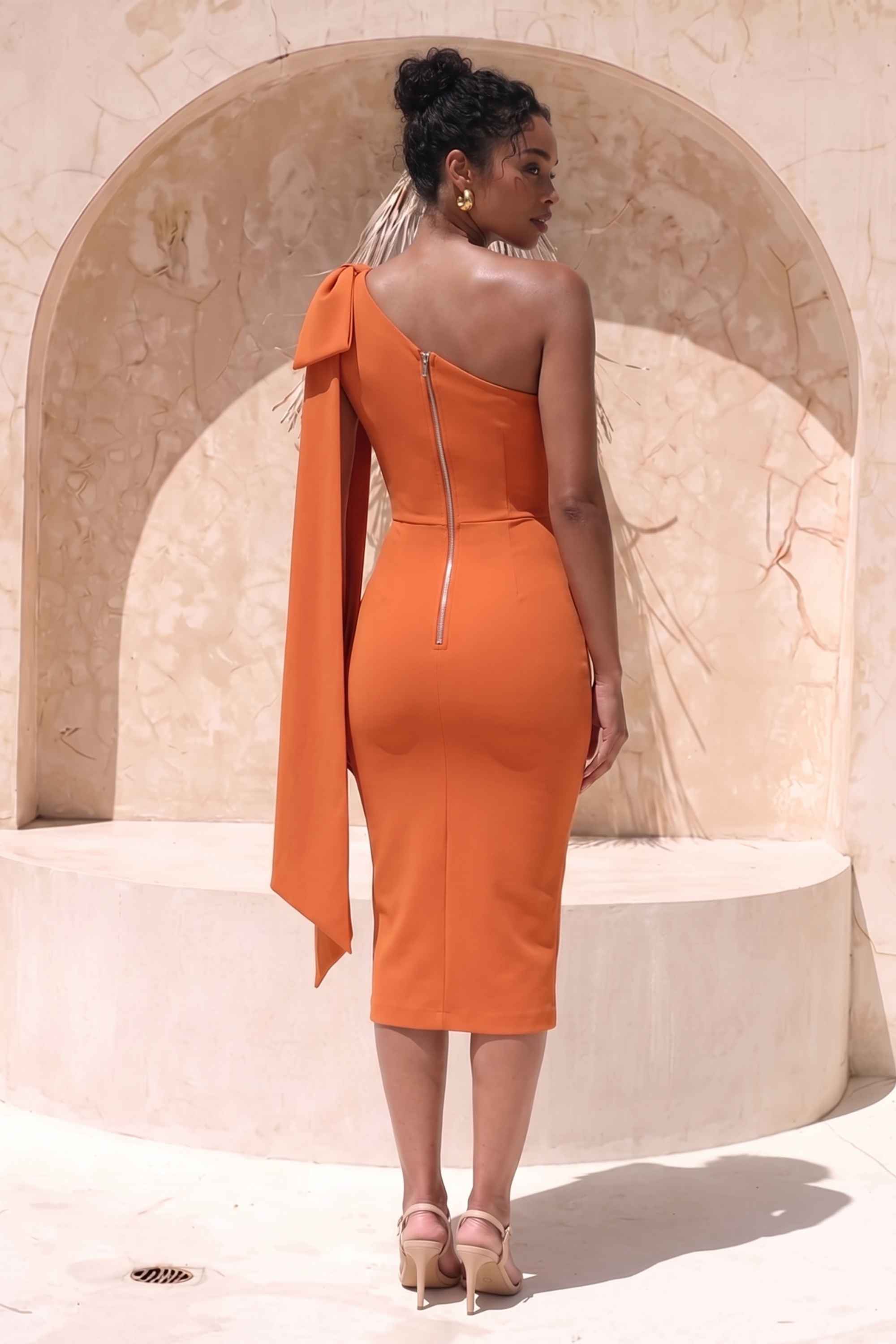 Woman wearing a figure flattering Lela Long Sleeve Bandage Midi Dress - Apricot Orange BODYCON COLLECTION
