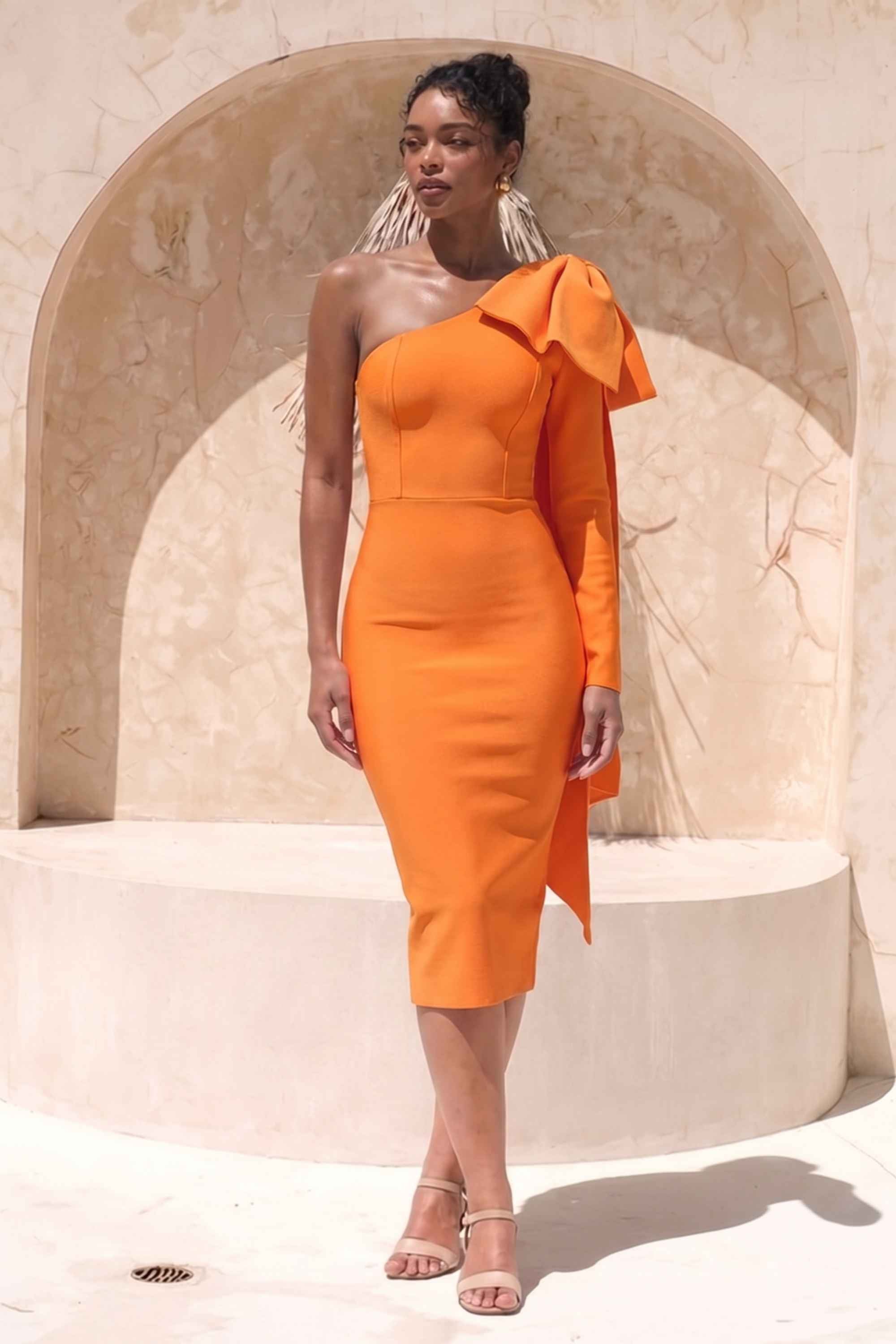Woman wearing a figure flattering Lela Long Sleeve Bandage Midi Dress - Apricot Orange BODYCON COLLECTION