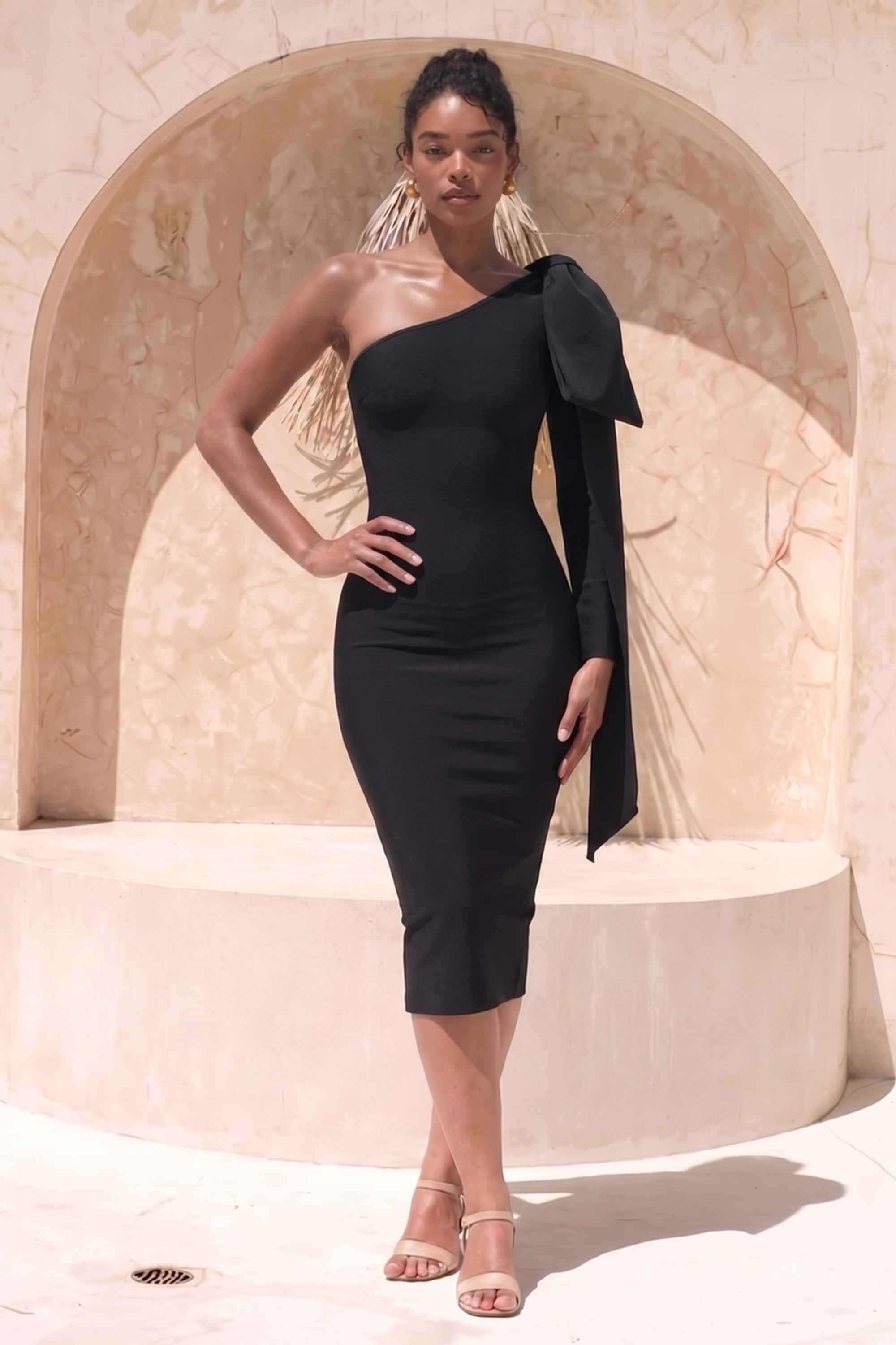 Woman wearing a figure flattering Lela Long Sleeve Bandage Midi Dress - Classic Black BODYCON COLLECTION