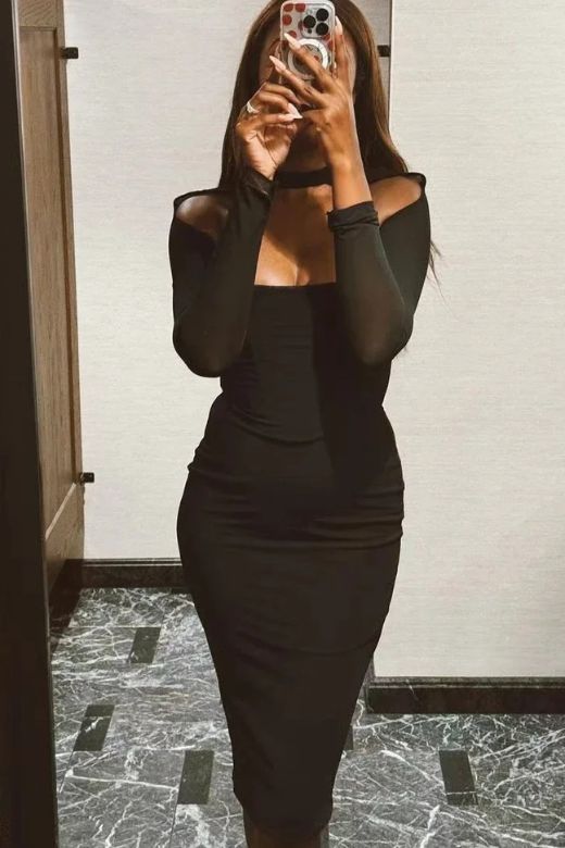 Woman wearing a figure flattering Lillian Bodycon Midi Dress - Classic Black BODYCON COLLECTION