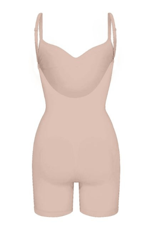 Woman wearing a figure flattering  Low Back One Piece Bodysuit Shapewear - Mid Thigh Bodycon Collection