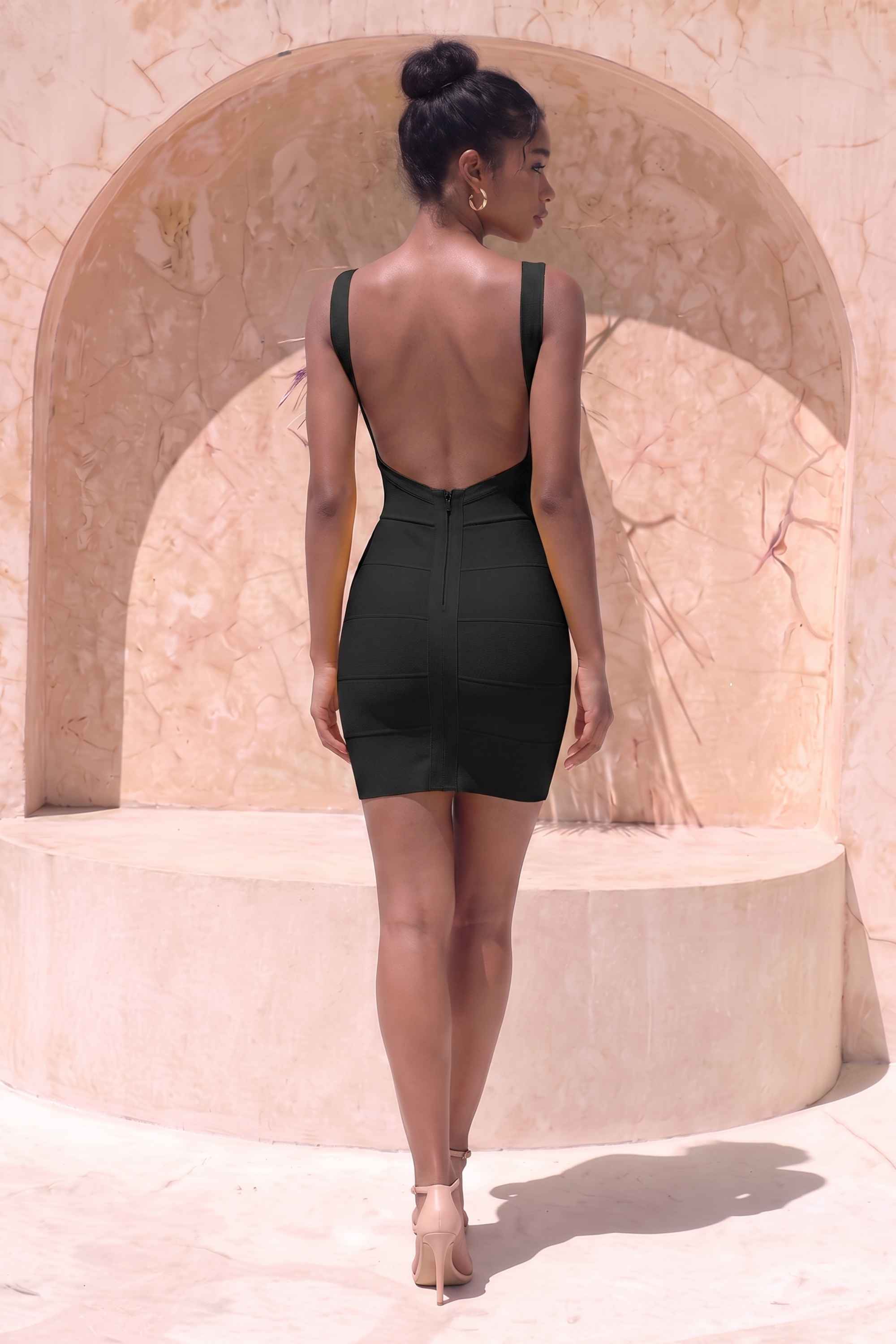 Woman wearing a figure flattering Maya Bandage Mini Dress - Classic Black BODYCON COLLECTION