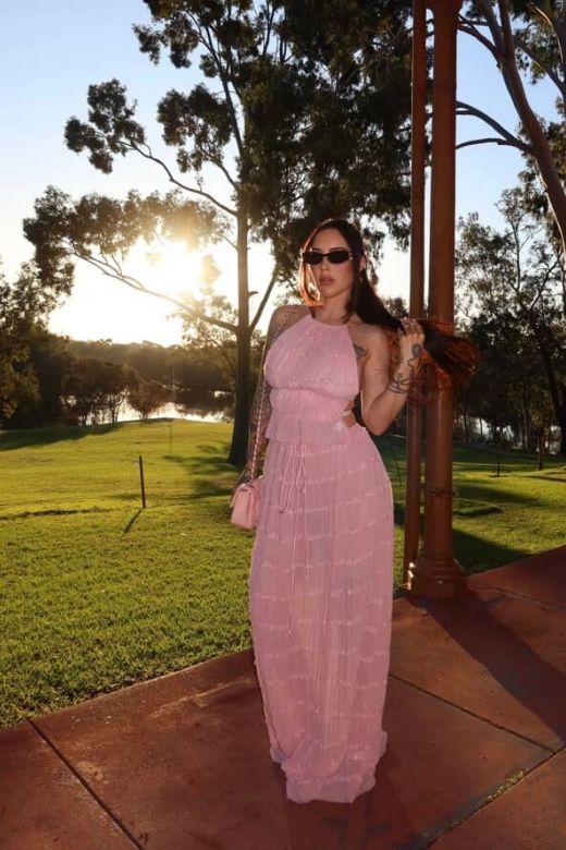 Woman wearing a figure flattering Meryl Wrap Top and Maxi Skirt Set - Pink Fuzz BODYCON COLLECTION
