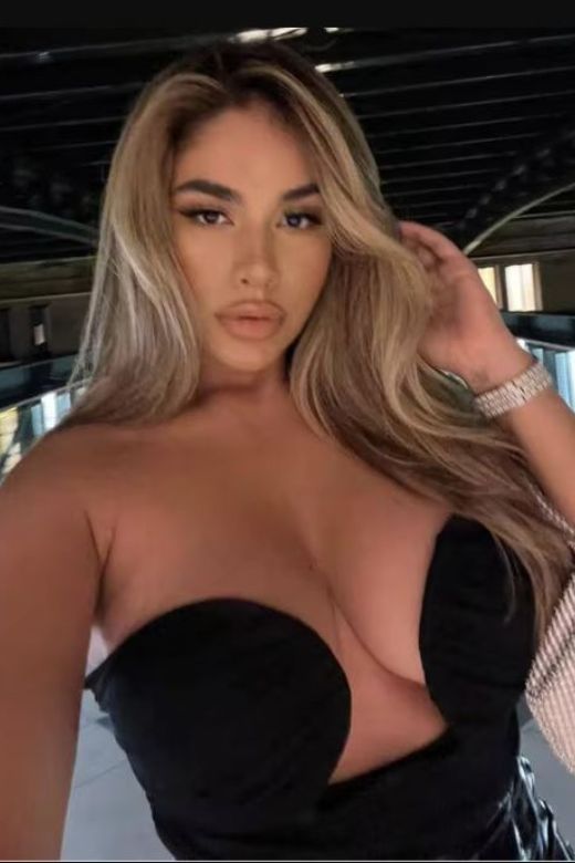 Woman wearing a figure flattering Mika Bandage Crop Top - Classic Black BODYCON COLLECTION