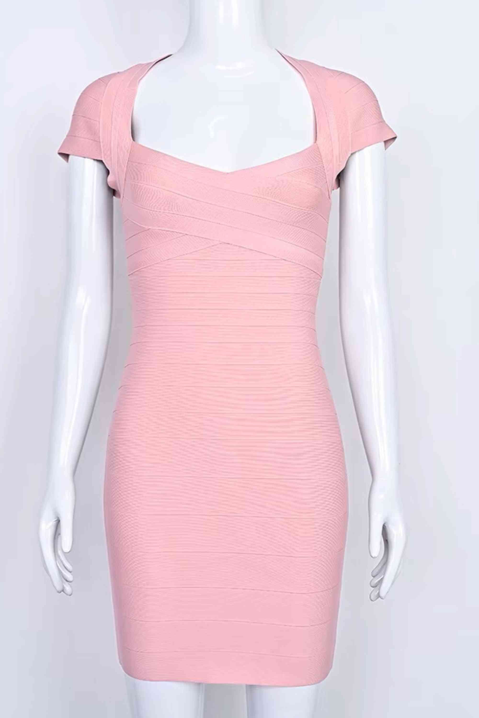 Woman wearing a figure flattering Miranda Bandage Mini Dress - Ballet Pink Bodycon Collection