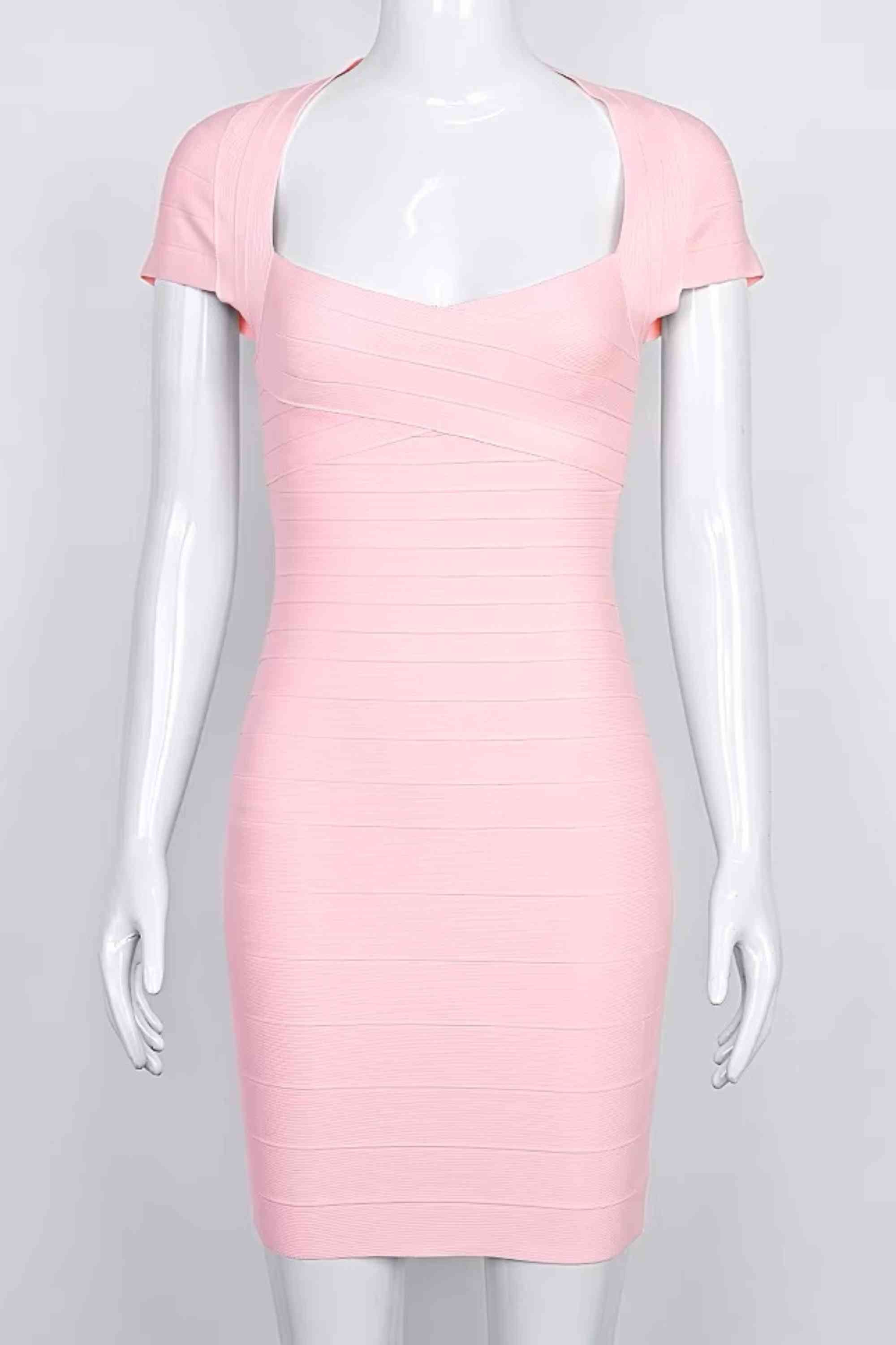 Woman wearing a figure flattering Miranda Bandage Mini Dress - Dusty Pink Bodycon Collection