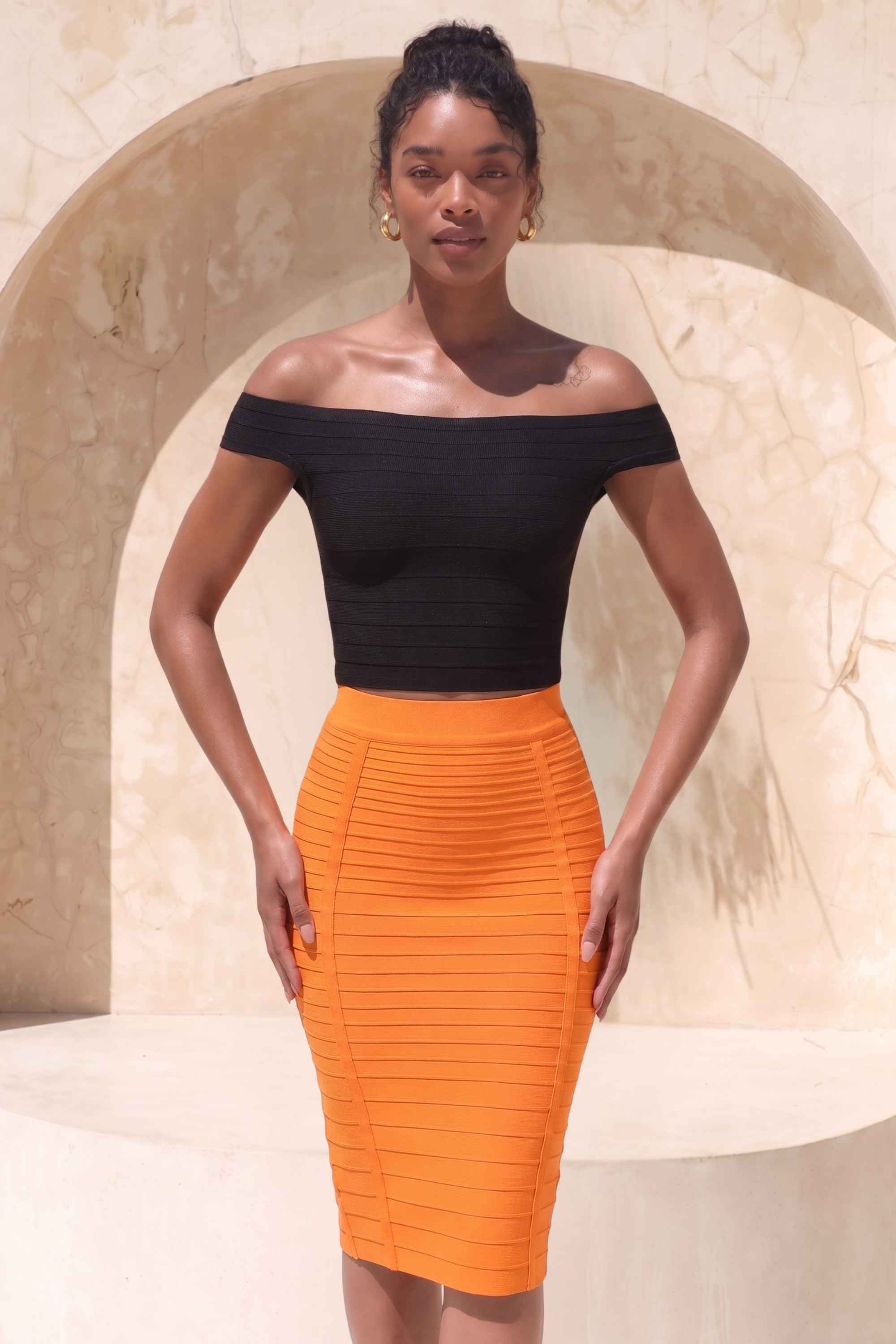 Woman wearing a figure flattering Pencil High Waist Bandage Knee Length Knitted Skirt - Apricot Orange BODYCON COLLECTION