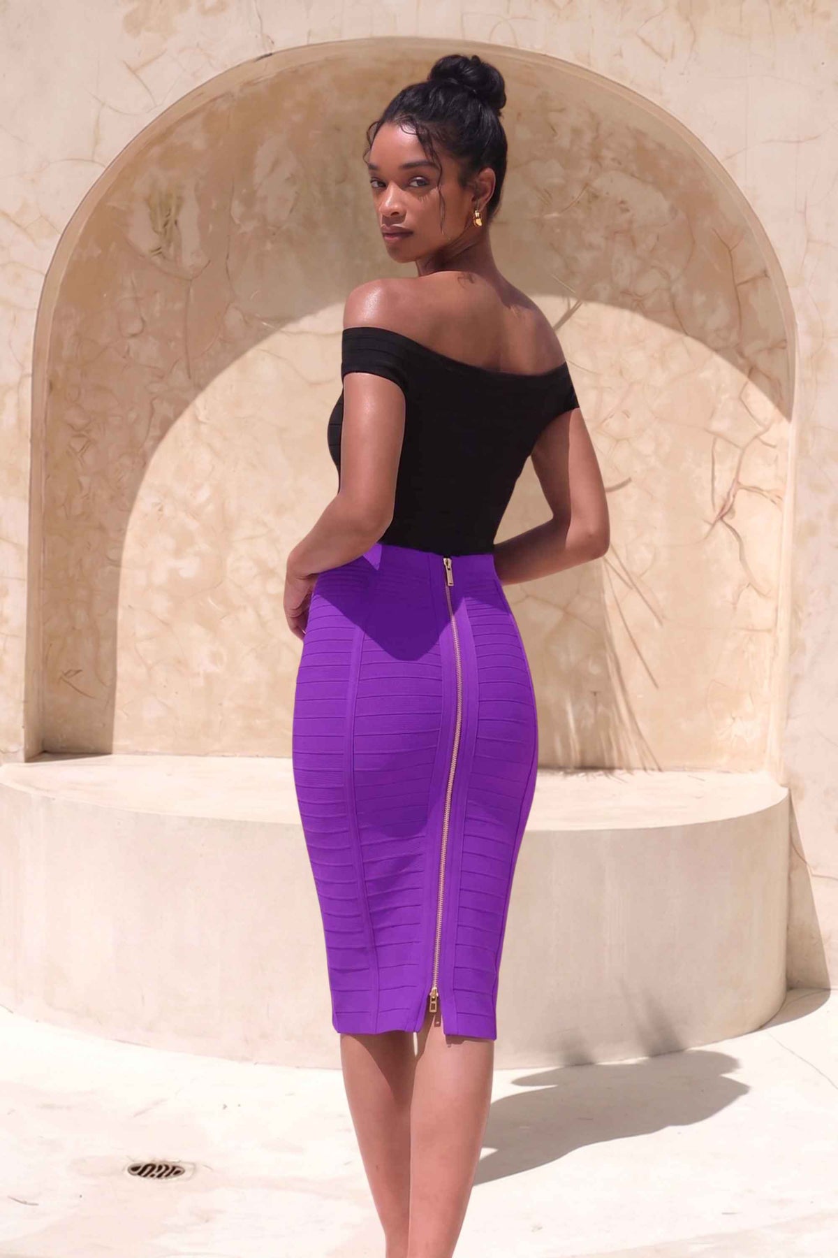 Woman wearing a figure flattering Pencil High Waist Bandage Knee Length Knitted Skirt - Plum Purple BODYCON COLLECTION