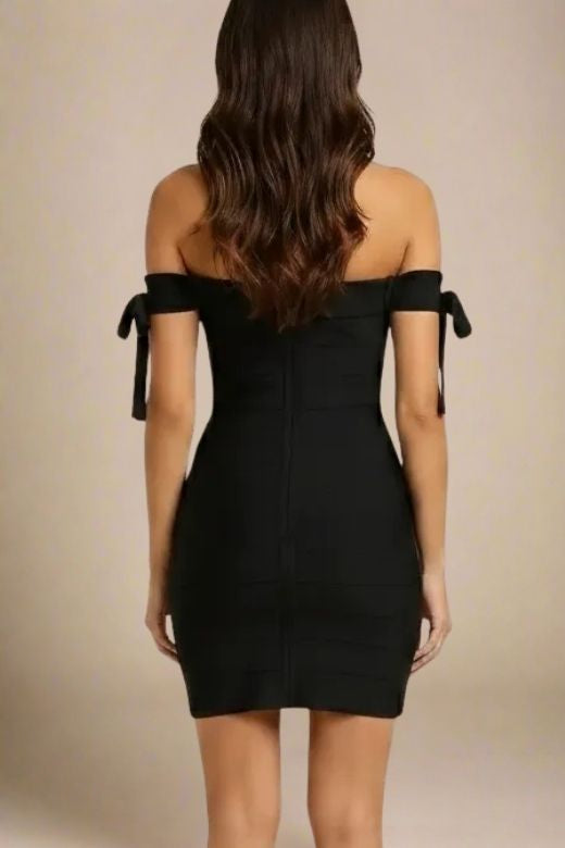 Woman wearing a figure flattering Penelope Bandage Mini Dress - Classic Black BODYCON COLLECTION