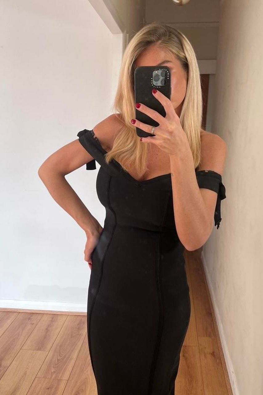 Woman wearing a figure flattering  Penelope Bandage Mini Dress - Classic Black BODYCON COLLECTION