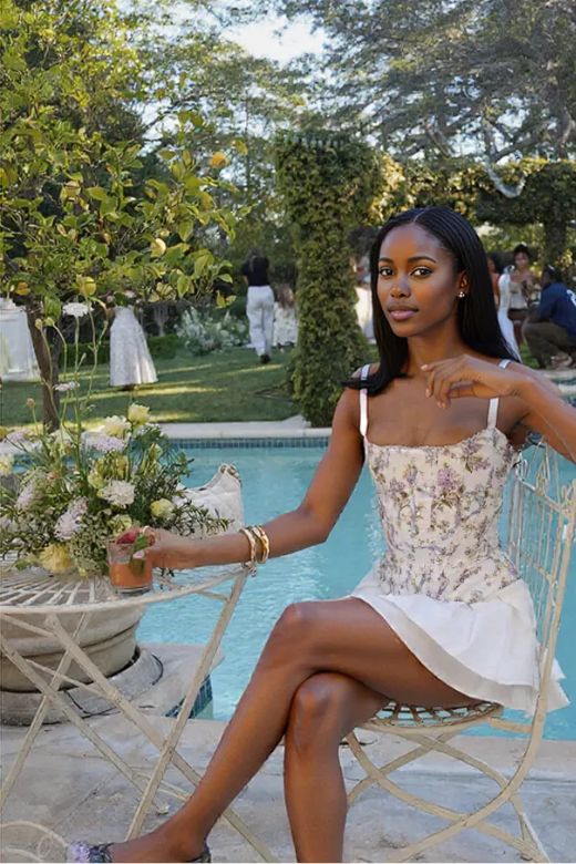 Woman wearing a figure flattering Penny Corset Top - White Floral BODYCON COLLECTION Pty Ltd