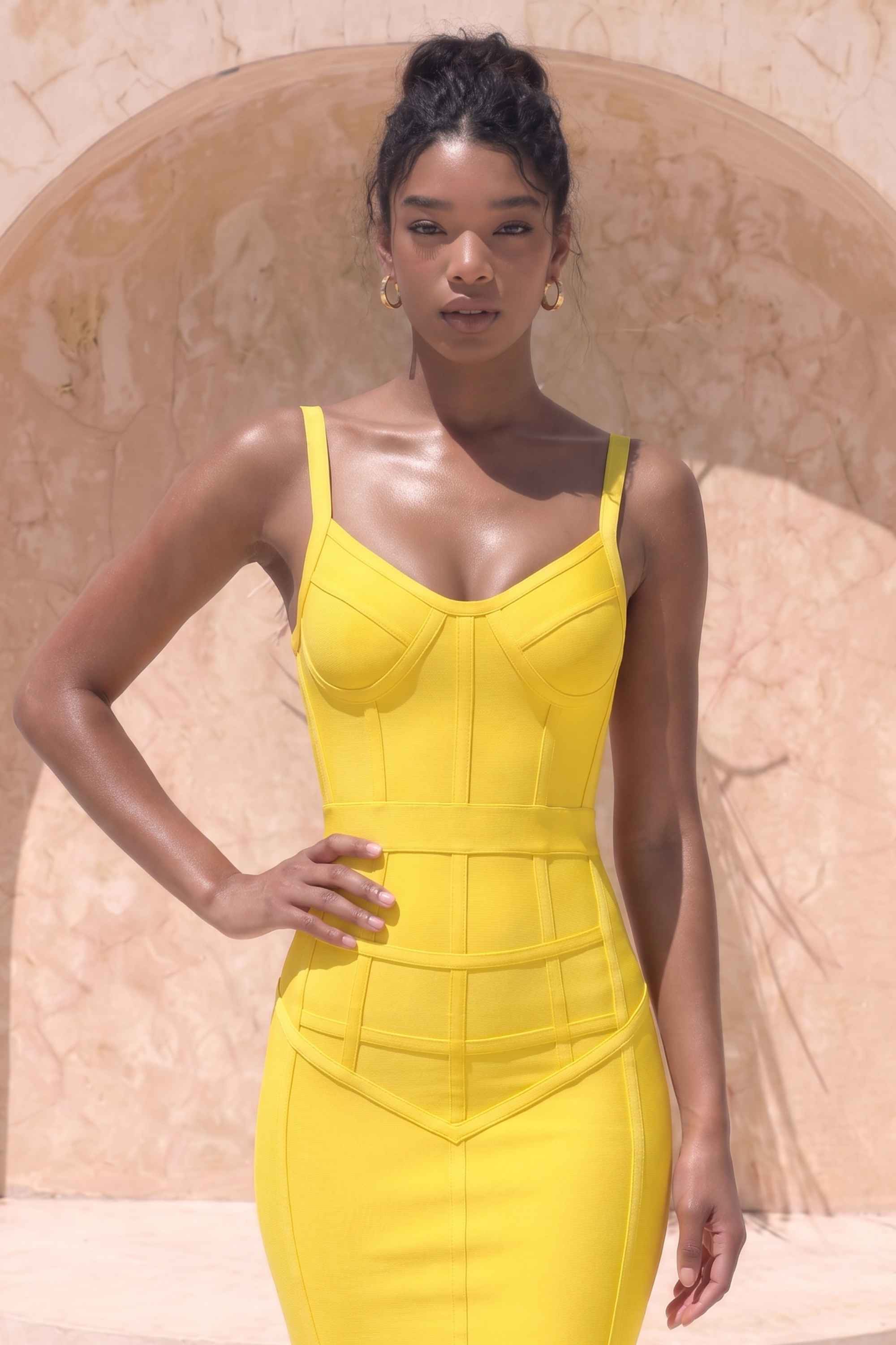 Woman wearing a figure flattering Pip Bandage Corset Dress - Sun Yellow Bodycon Collection