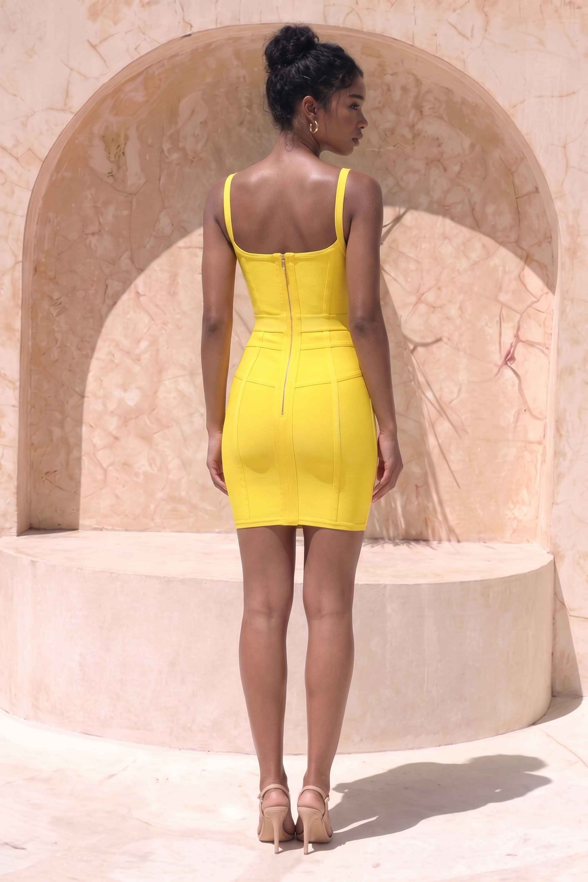 Woman wearing a figure flattering Pip Bandage Mini Dress - Sun Yellow BODYCON COLLECTION