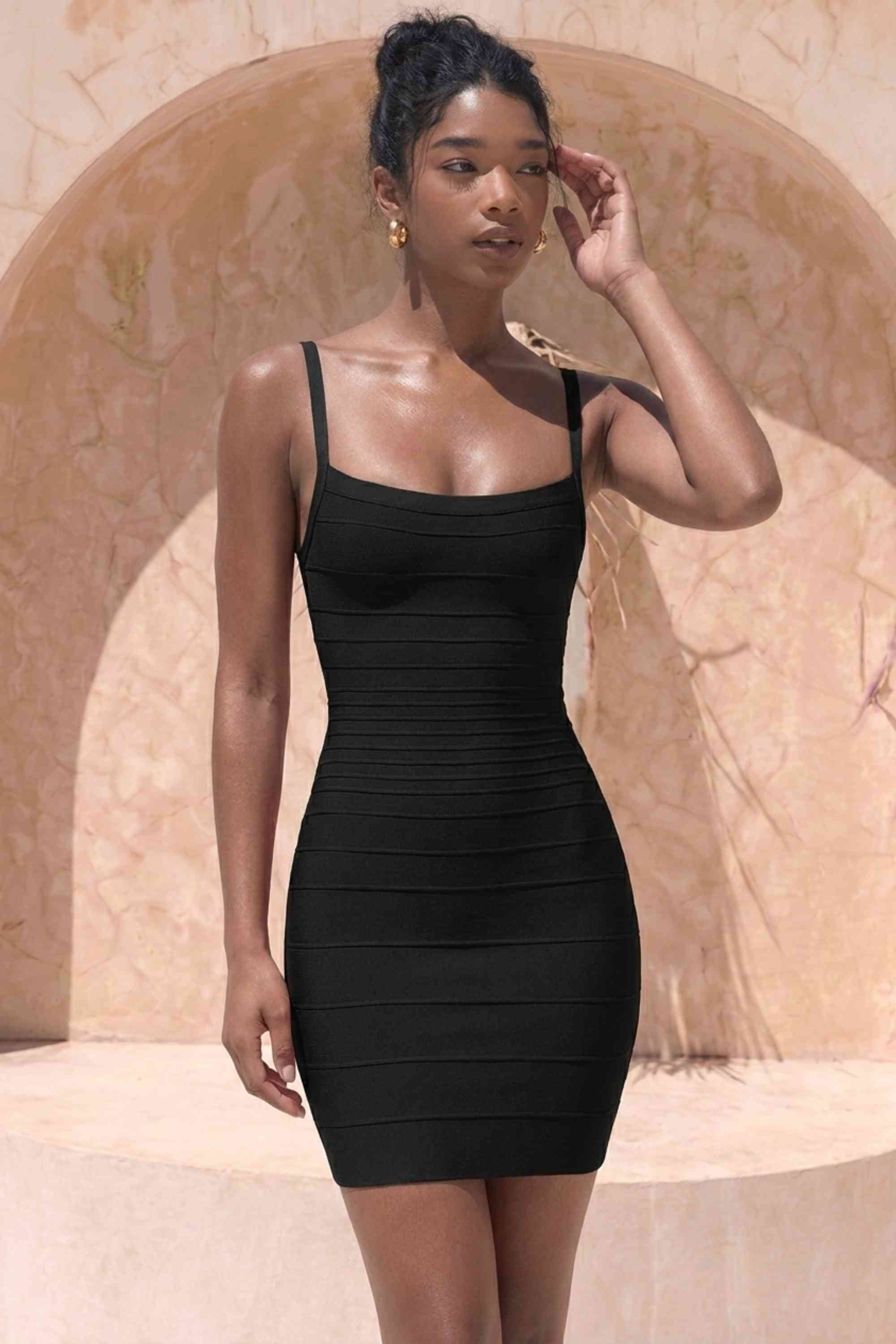 Woman wearing a figure flattering Scarlett Bandage Mini Dress - Classic Black BODYCON COLLECTION Pty Ltd