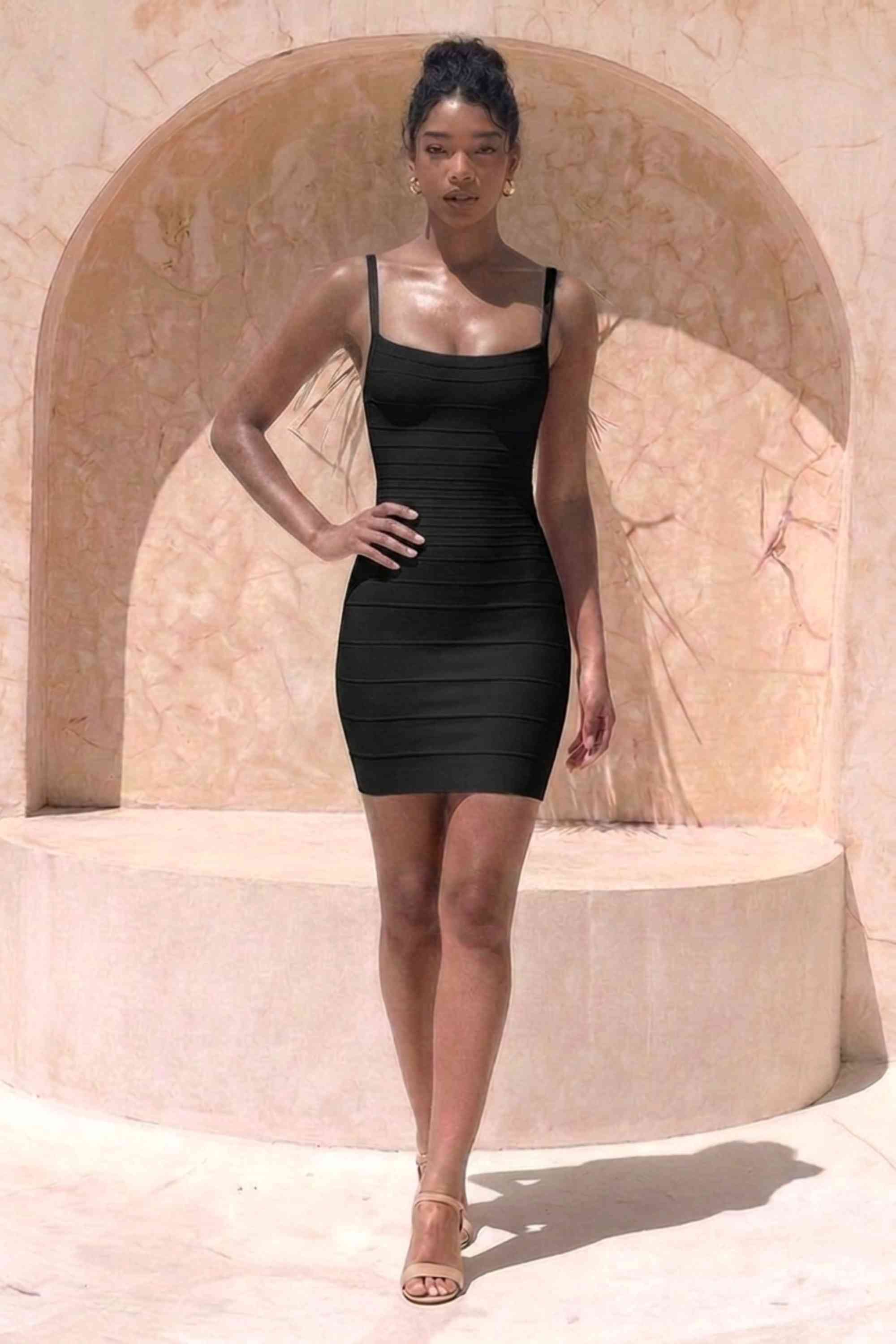 Woman wearing a figure flattering Scarlett Bandage Mini Dress - Classic Black BODYCON COLLECTION Pty Ltd