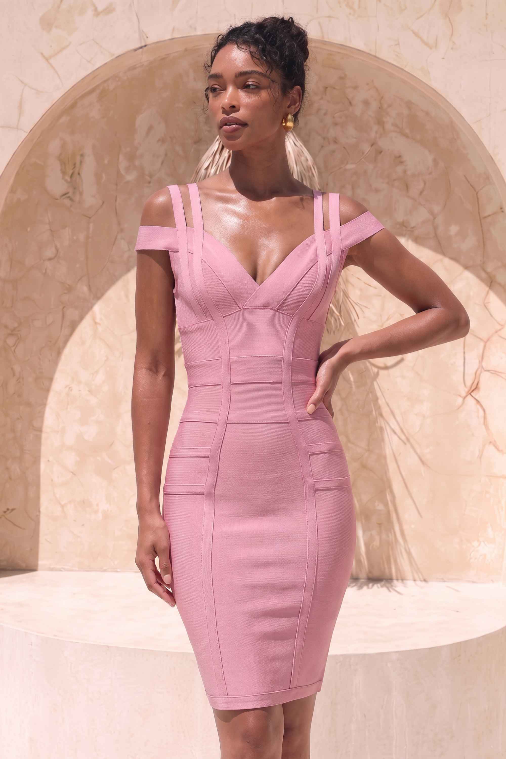 Woman wearing a figure flattering Sia Bandage Dress - Ballet Pink Bodycon Collection