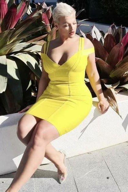 Woman wearing a figure flattering  Sia Bandage Dress - Classic Black Bodycon Collection