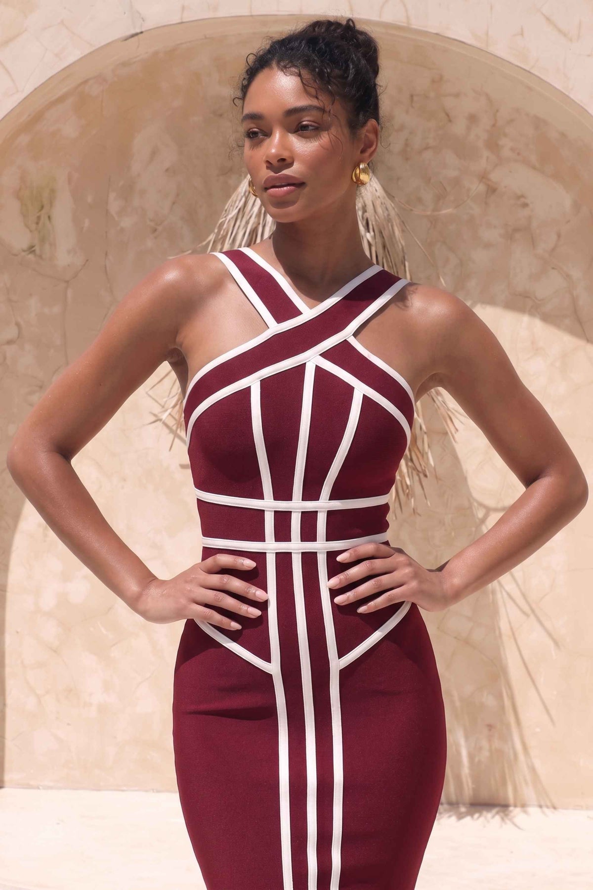 Woman wearing a figure flattering Suki Bandage Midi Dress - Red Wine BODYCON COLLECTION