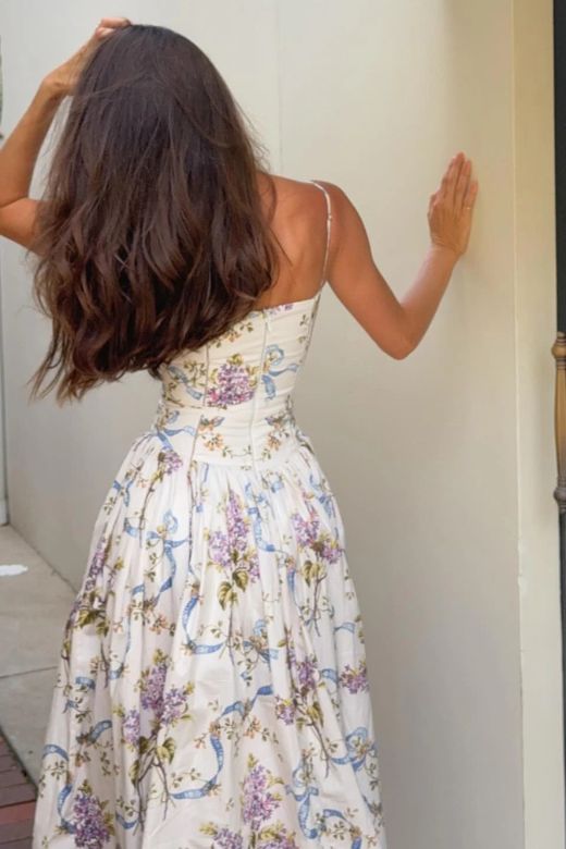Woman wearing a figure flattering Tasmin Bodycon Midi Dress - White Floral BODYCON COLLECTION